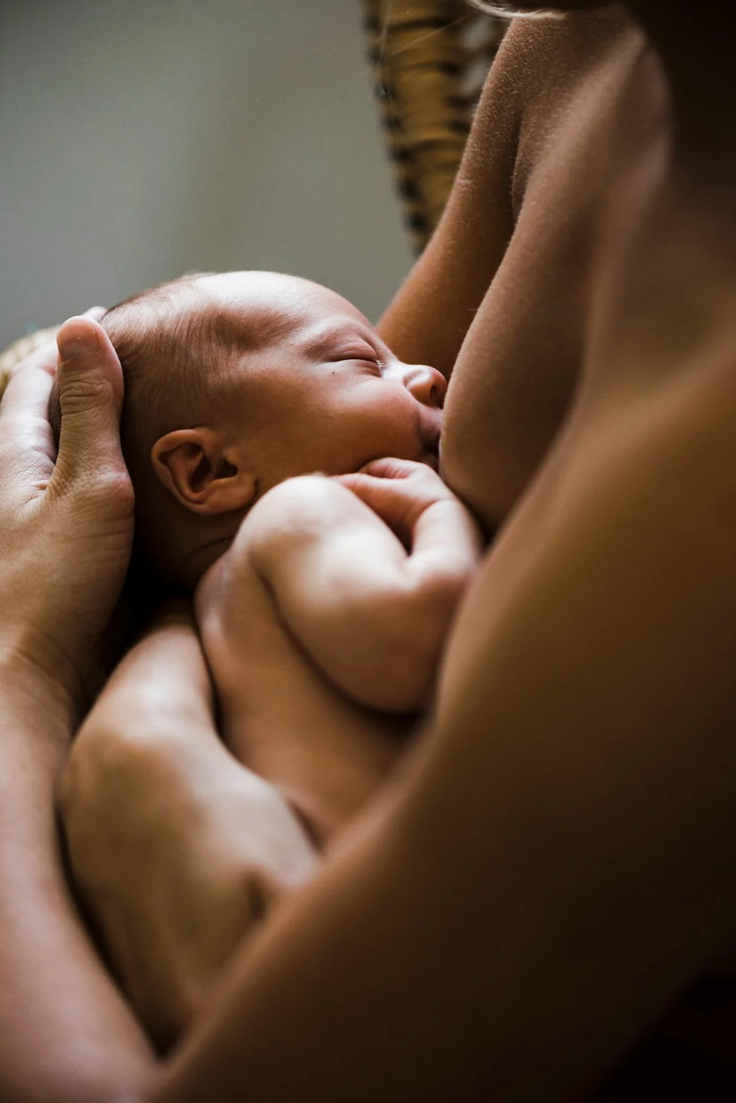 A baby being breastfed by a woman in close-up