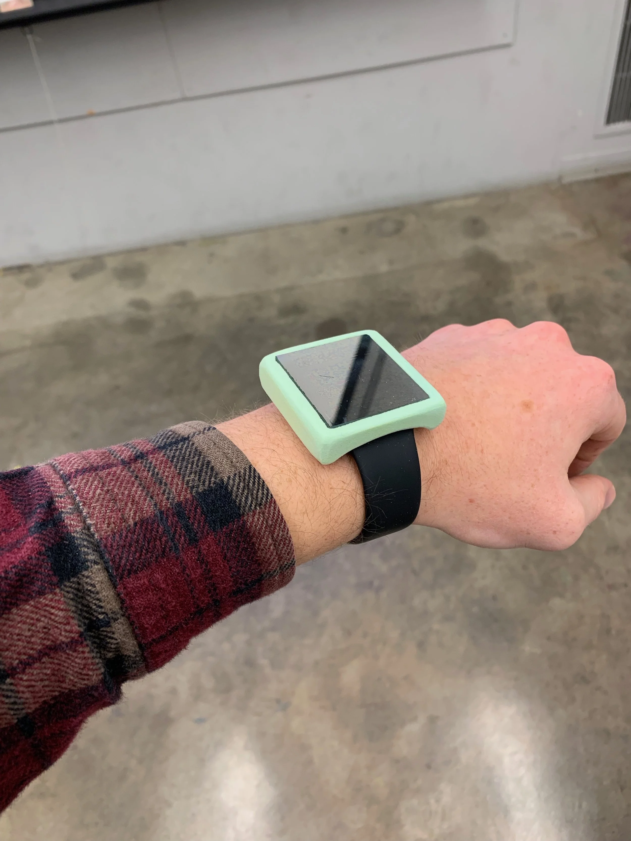 The final high-fidelity wizard-of-oz prototype. A foam casing and plastic two-way mirror on top of an Apple Watch.