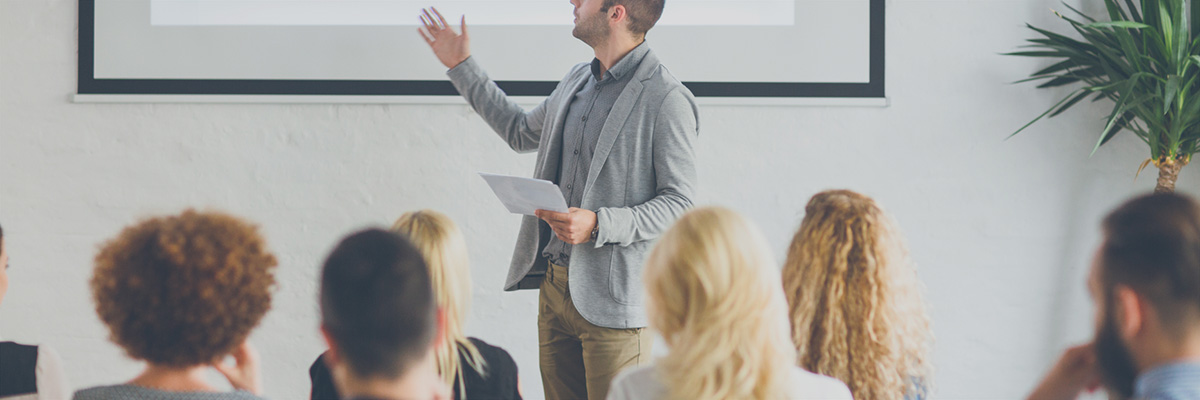 Man+giving+business+presentation+to+small+crowd.jpg