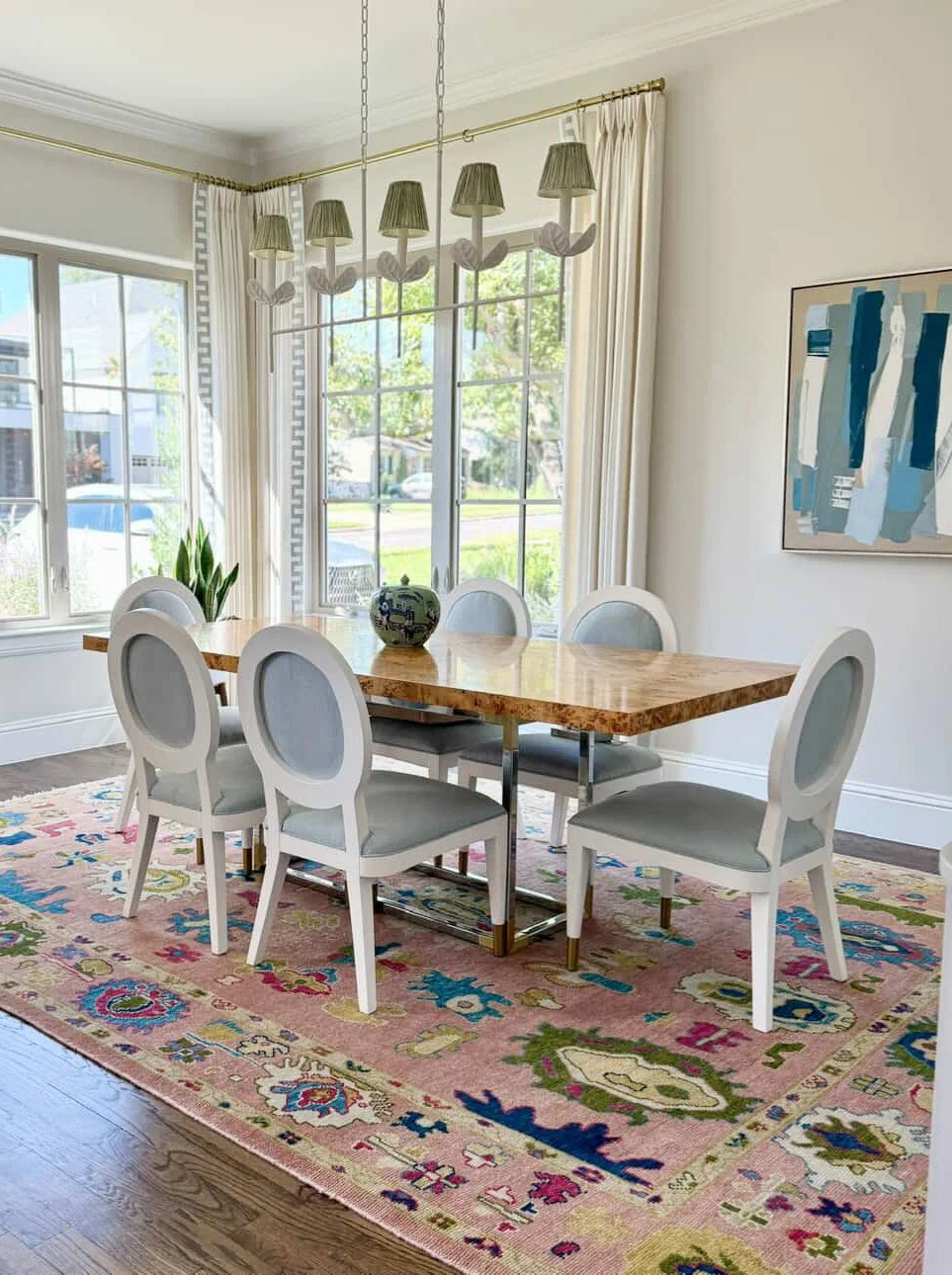 A framed painting on raw linen complements the colorful accents in this dining room