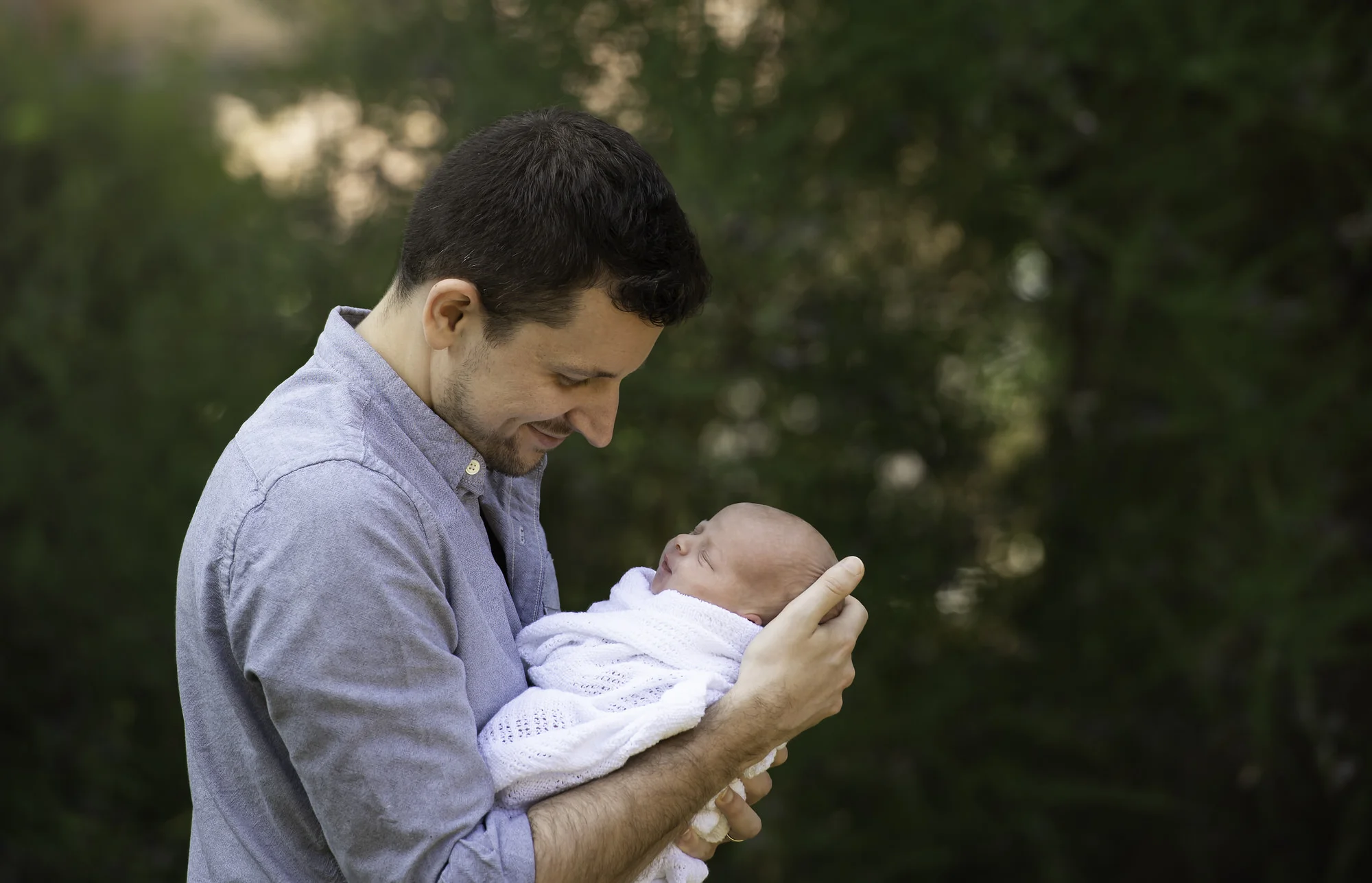 Father with newborn daughter outdoors