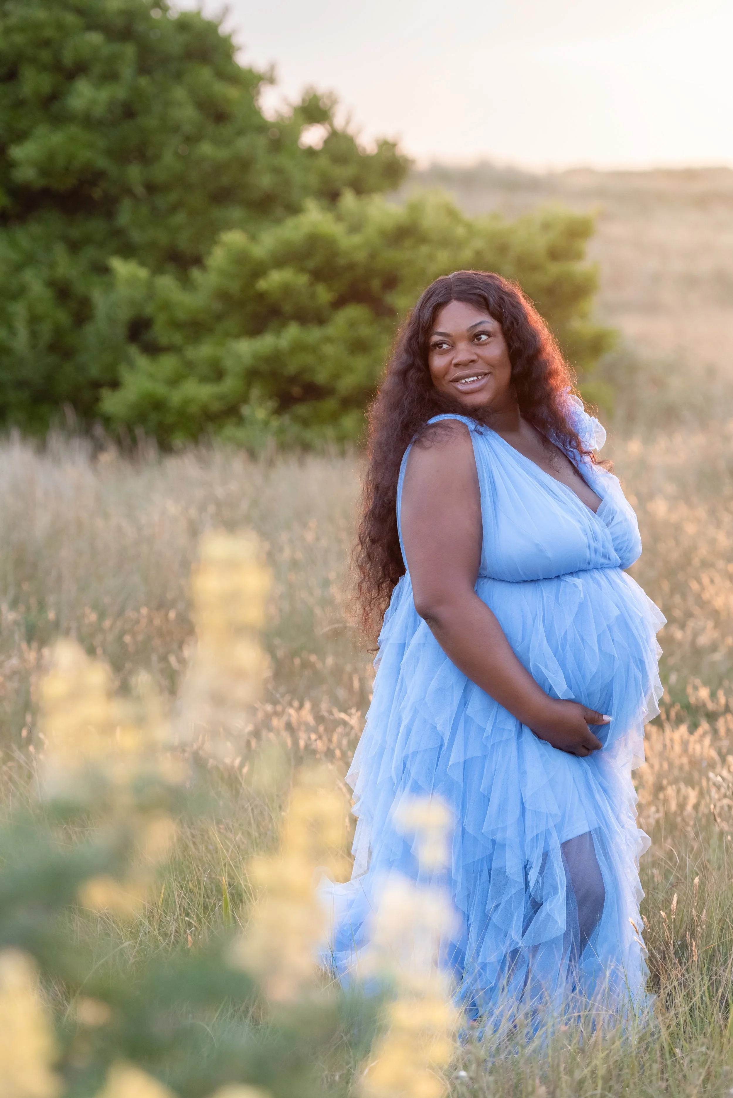Jersey photographer - maternity portrait amongst lupin flowers
