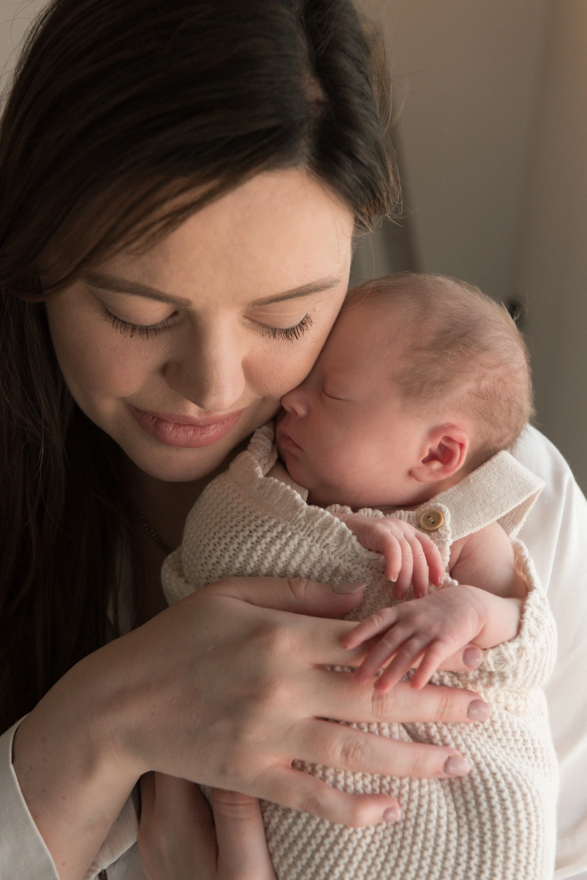 Jersey photographer - newborn girl cuddling into mother