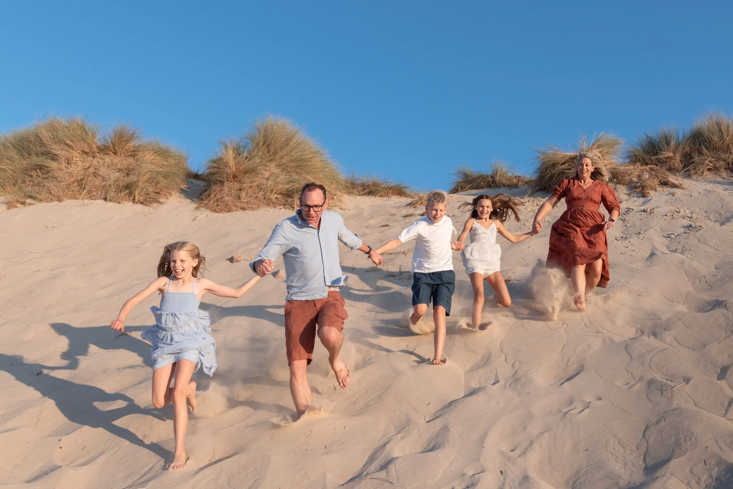 Jersey photographer - family running in dunes
