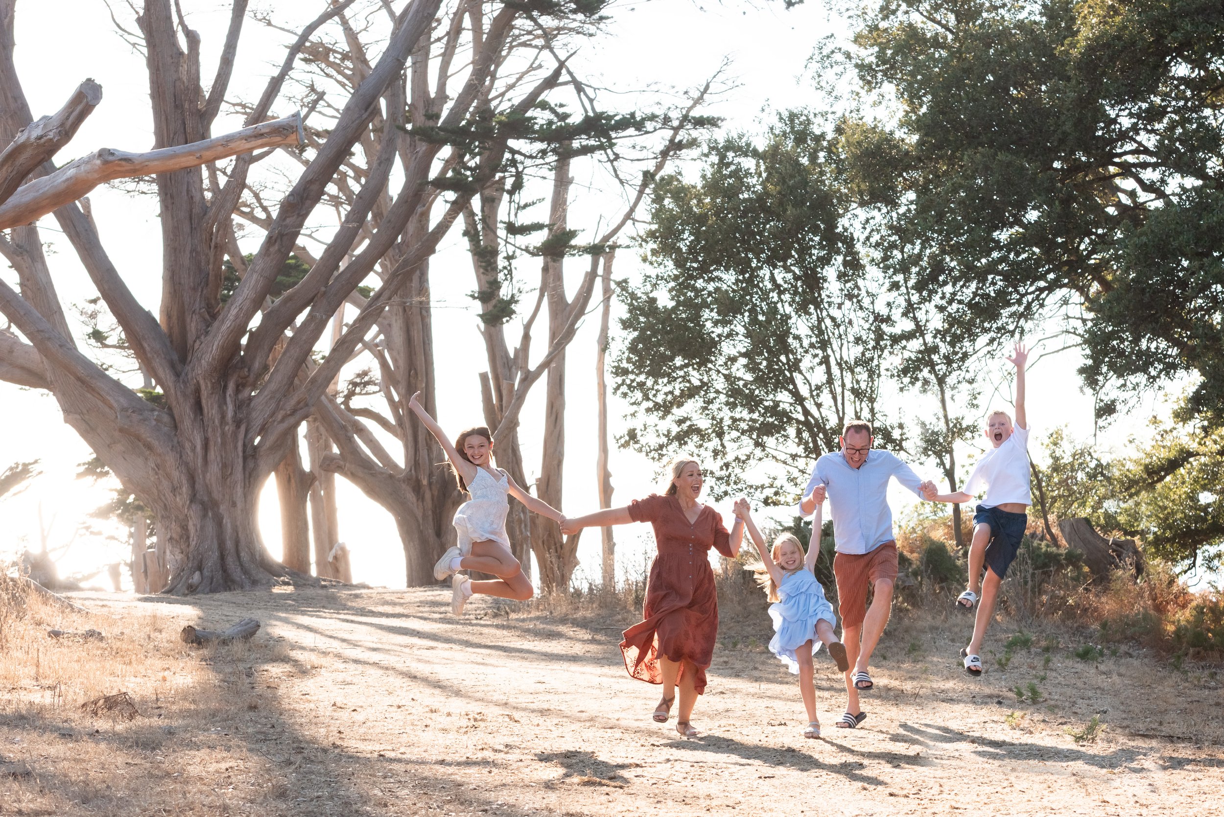 Jersey photographer - family skipping at Grantez