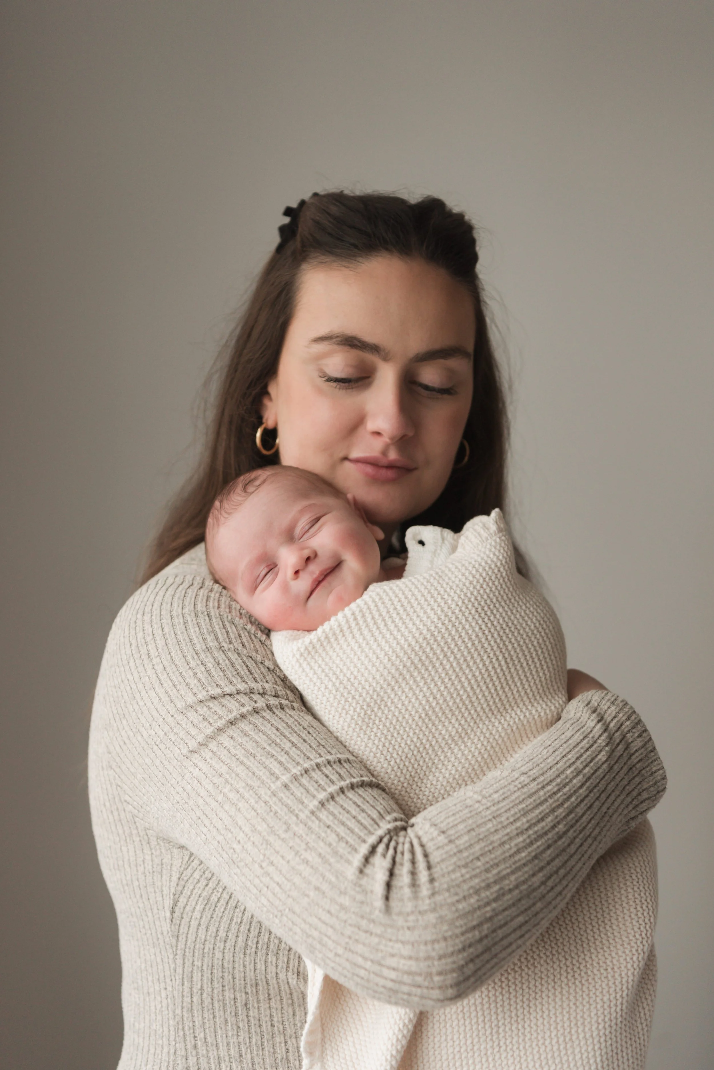Jersey photographer - mother cradling newborn