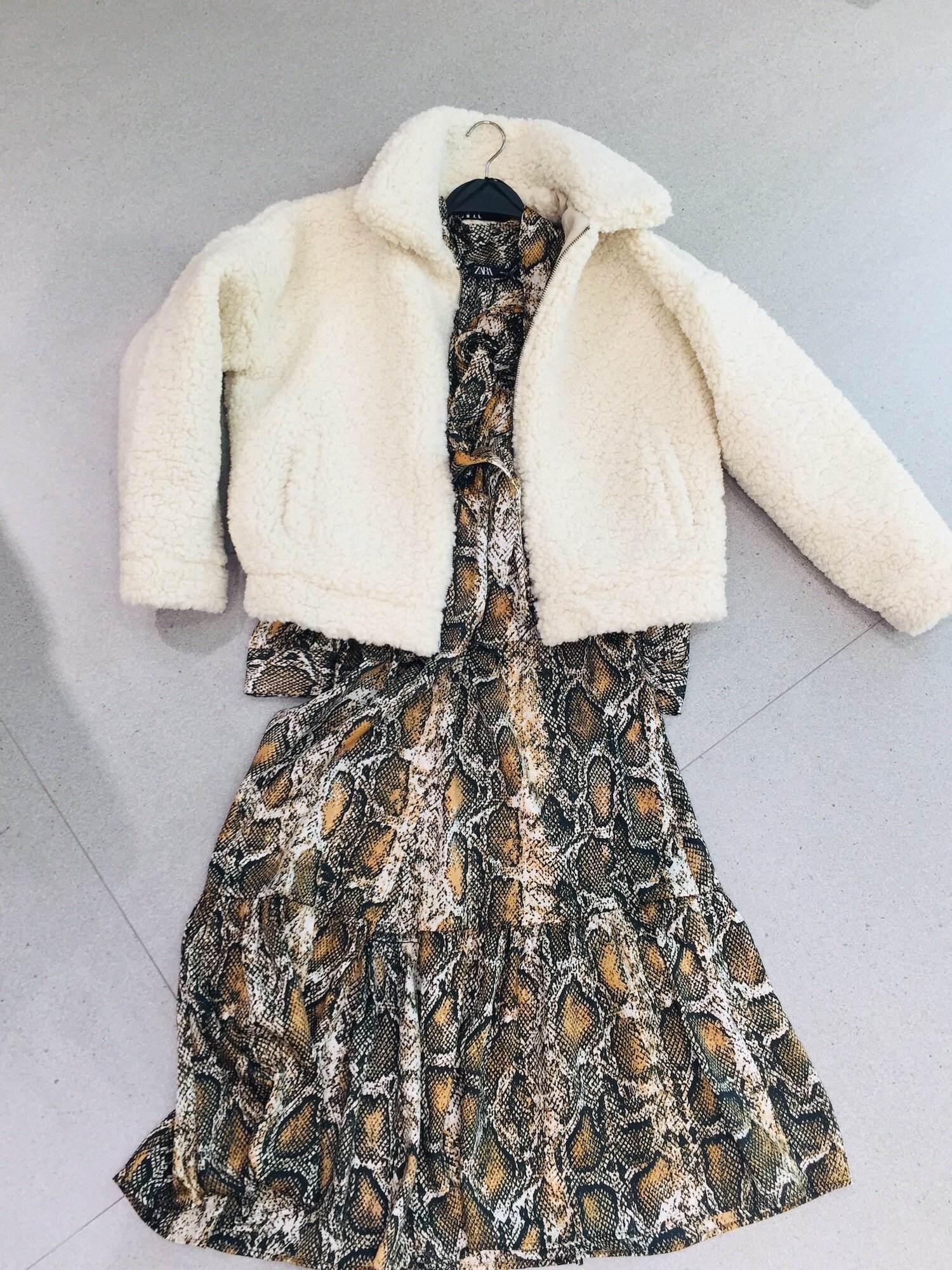 Your personal brand is important at work. Leopard and snakeskin prints are all the rage this fall; why not try the trend in a silk dress? Paired with a tall flat boot it is office appropriate, and with black or white kicks it’s perfect for a weekend outing. We love the mixing of textures - silk dress and fluffy bomber - that make this look unique. Outfit from Zara.