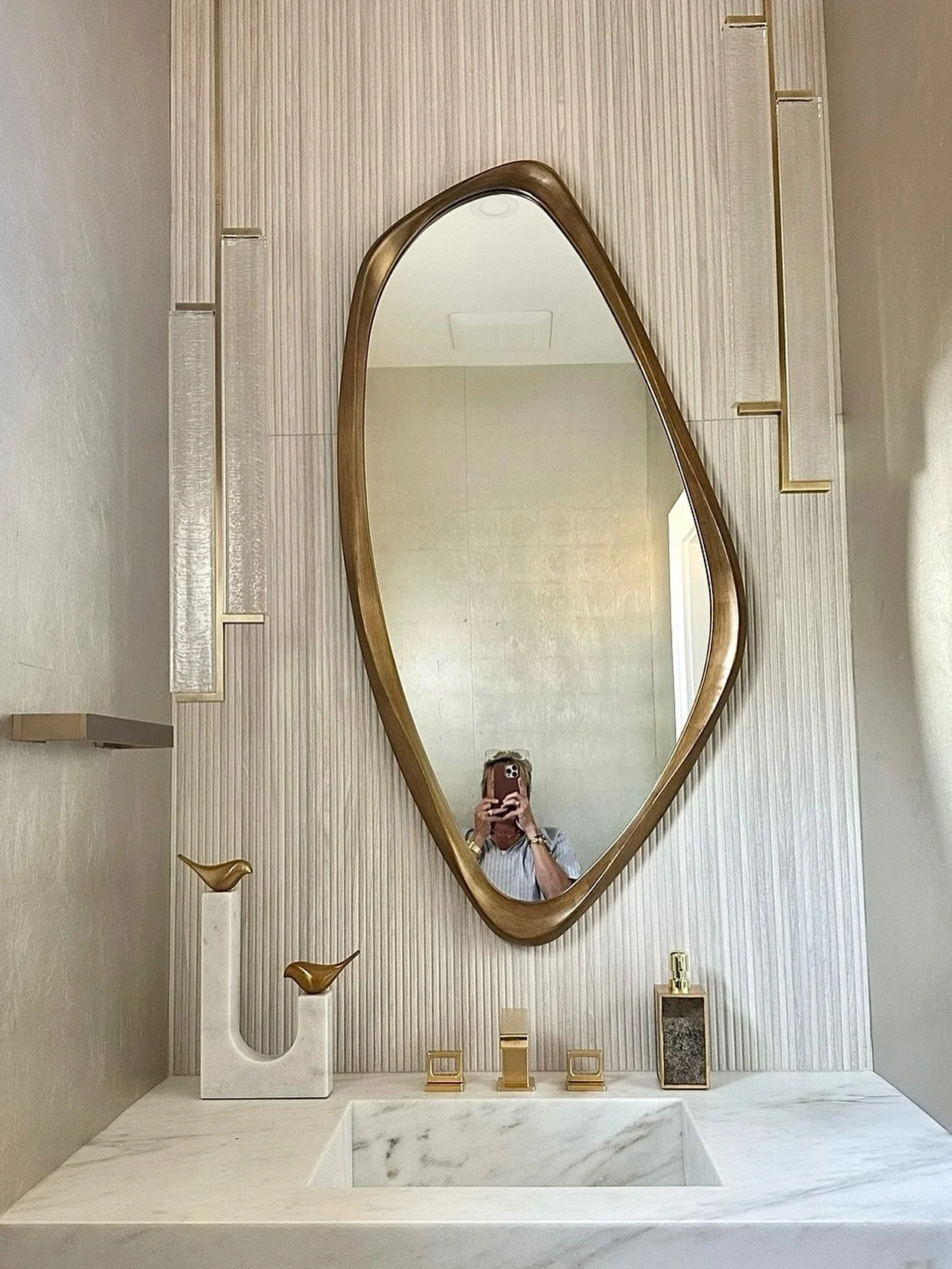 We love how this wonky mirror and stunning sconces fill the very tall space in this special glam powder room

Project: &ldquo;Lakeside Luxe&rdquo;
Interiors: @stoneledge.farm.home
Builder: @goosecreekvt

#stoneledgefarmhome#stoneledgestudio#interiors