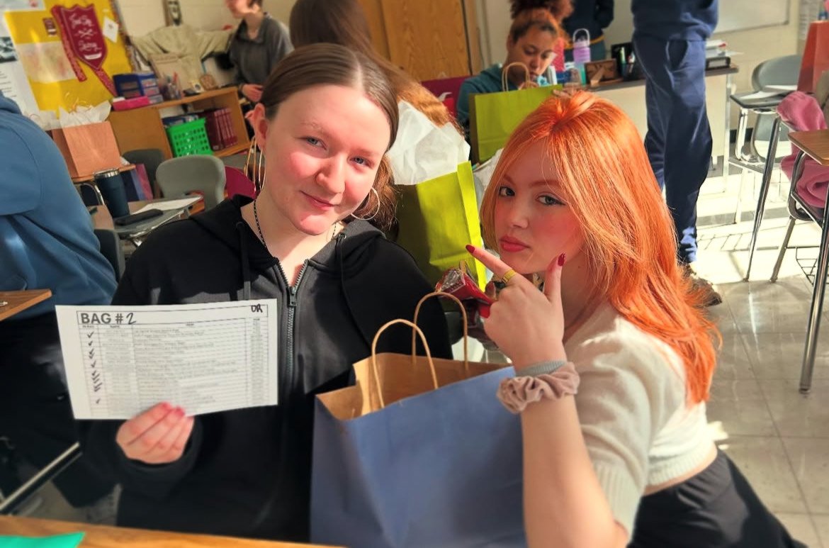 Club leader Ida Zoldos and one of our members on Day 1, posing with the premade item checklists for the packages.