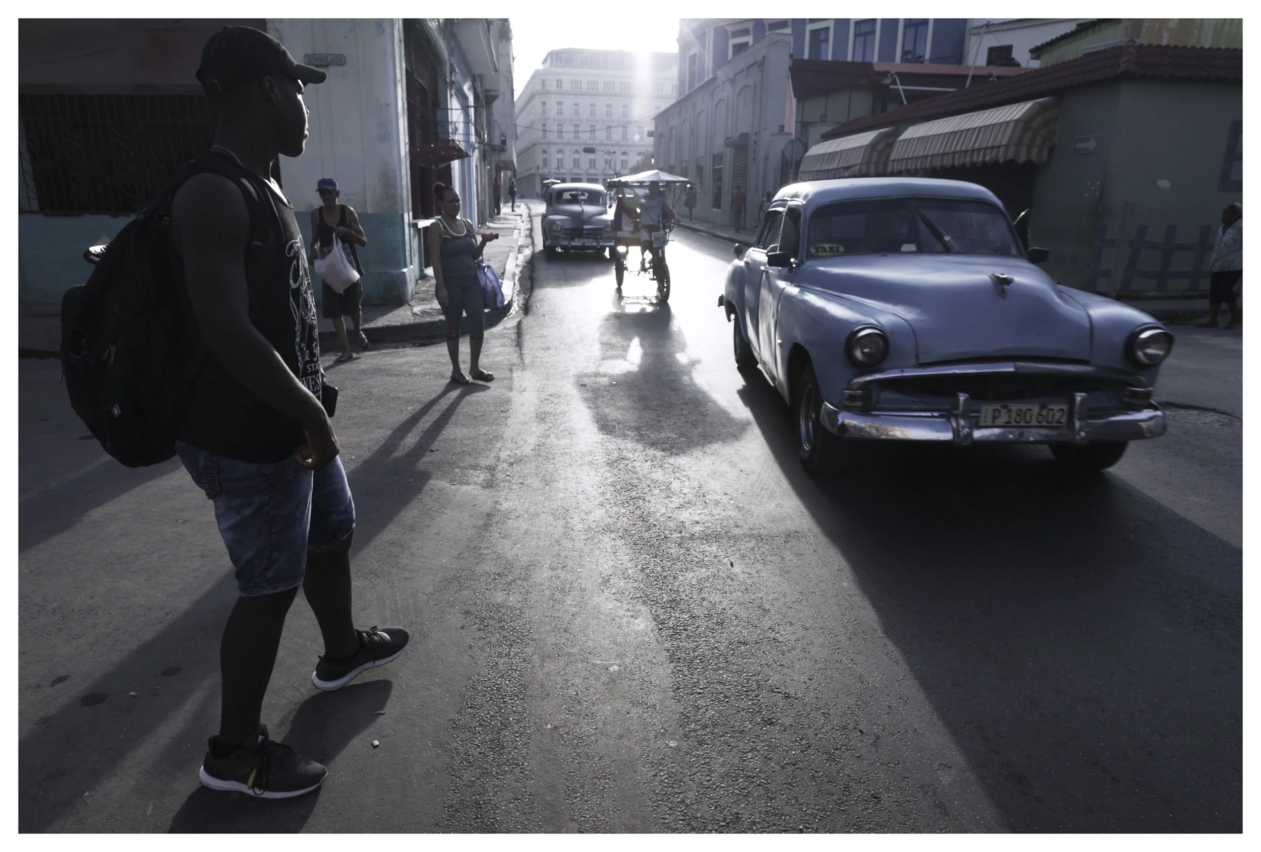 Commuters hitching a ride on local taxis 1/200 f/10 ISO 250 at 24mm