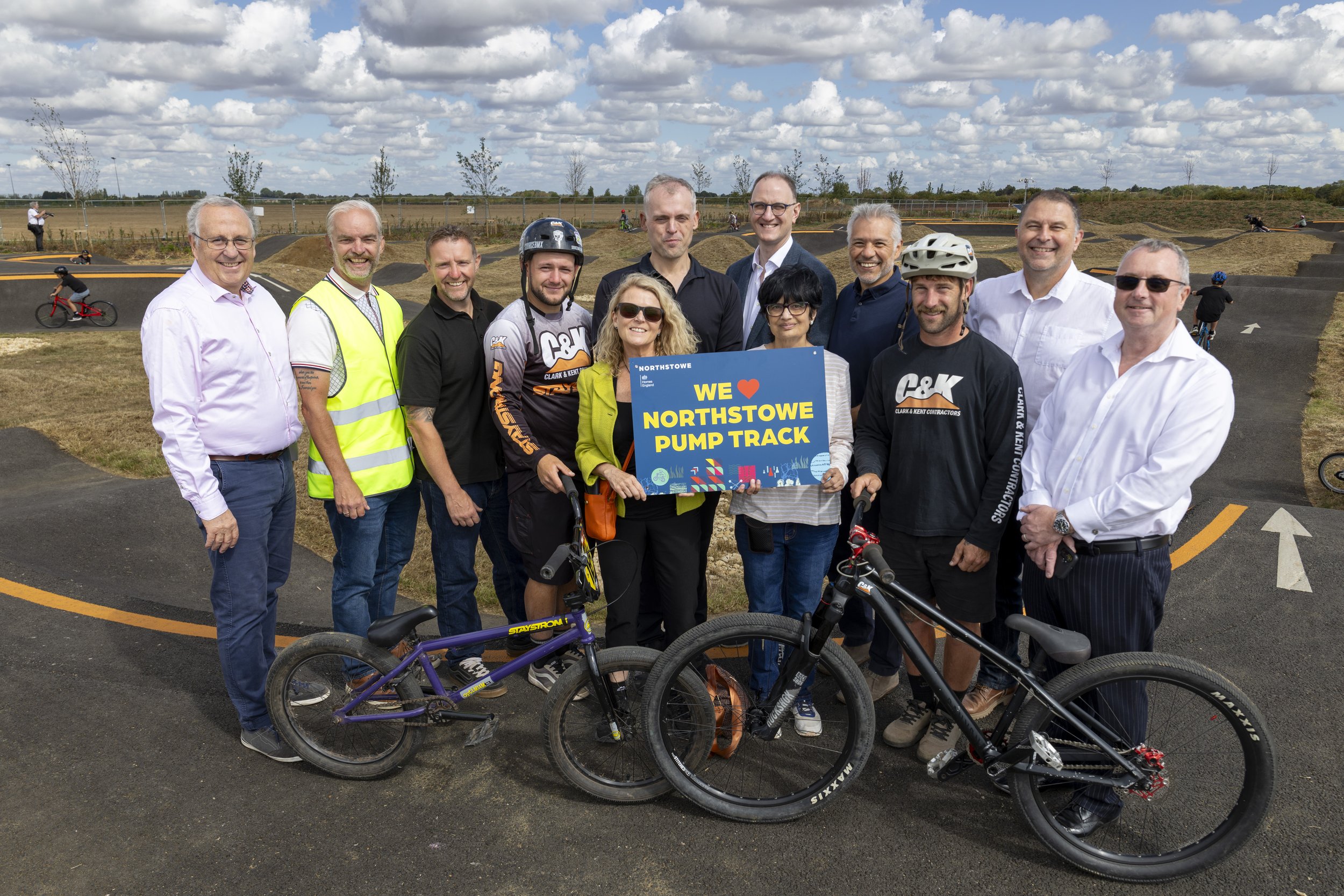 Stakeholders holding up a Northstowe sign at Northstowe Pump Track.