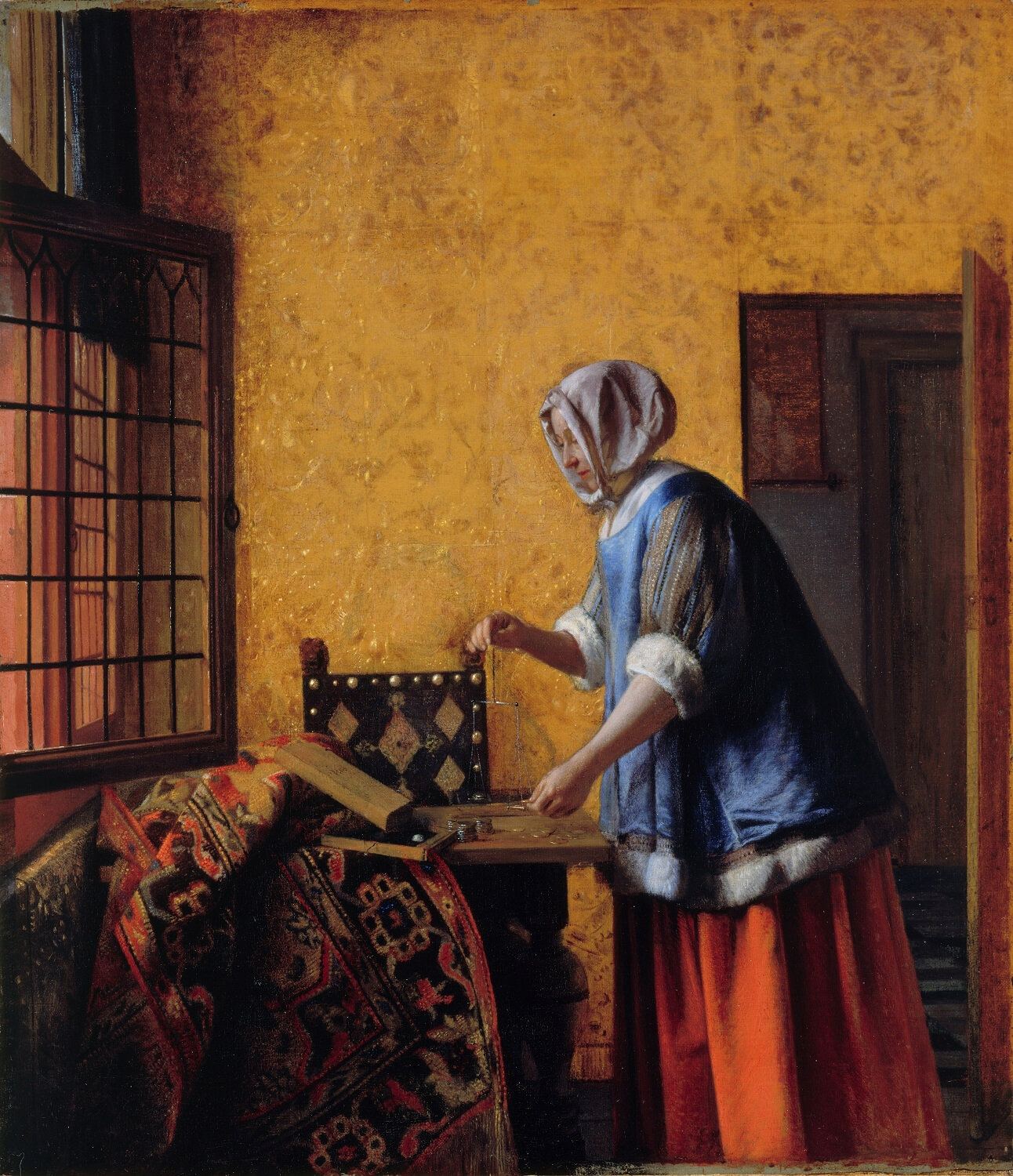 woman weighing gold and silver coins.jpg