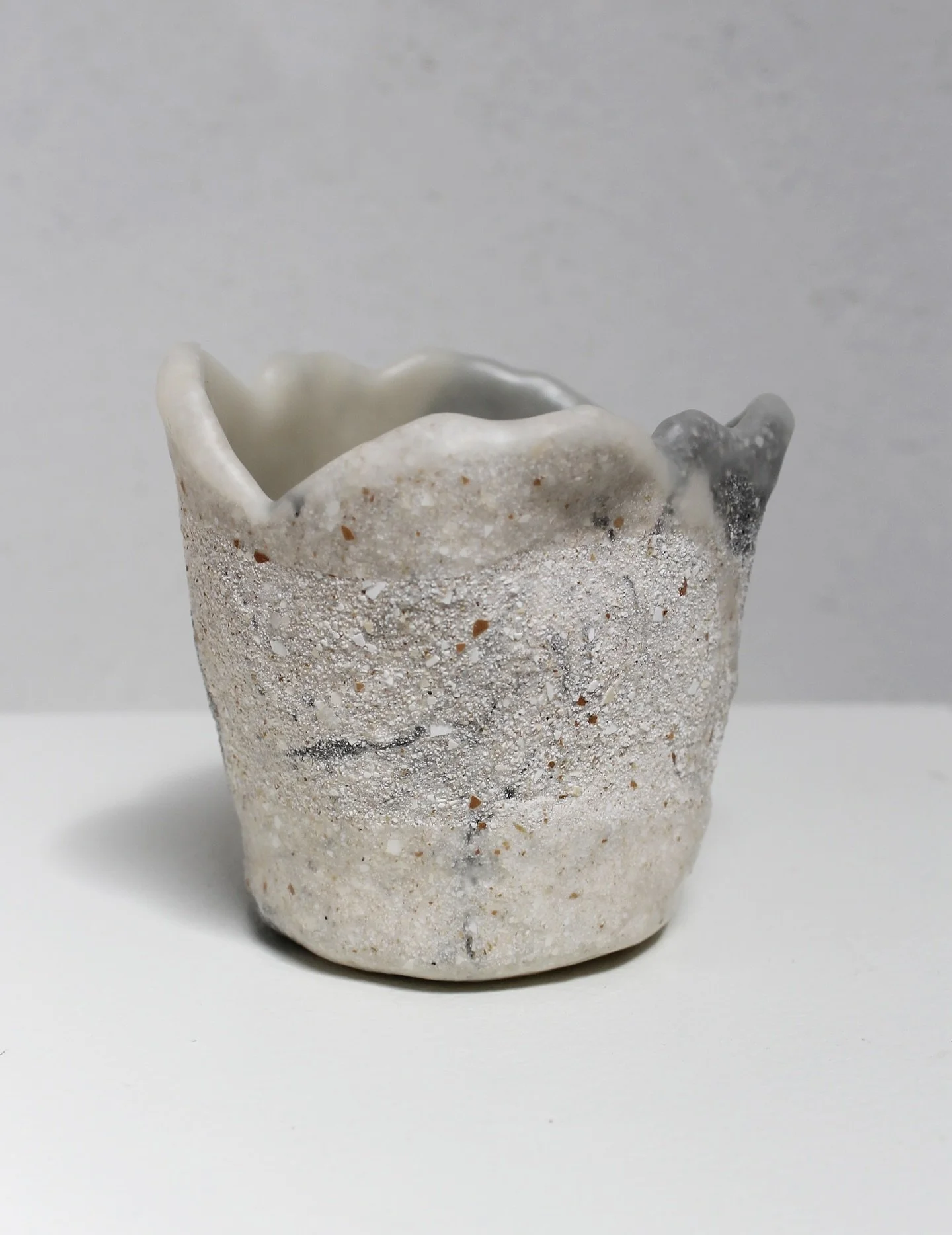 Eggshell Re-Planter no.20
Unique piece

Different look from every angle. 
Colourant: @ourcarbon.co 
Made from a dozen of discarded consumer eggshells. 
Height: 6cm
Diameter: 6cm

Handcrafted in The Netherlands 
Online: &euro;24,95