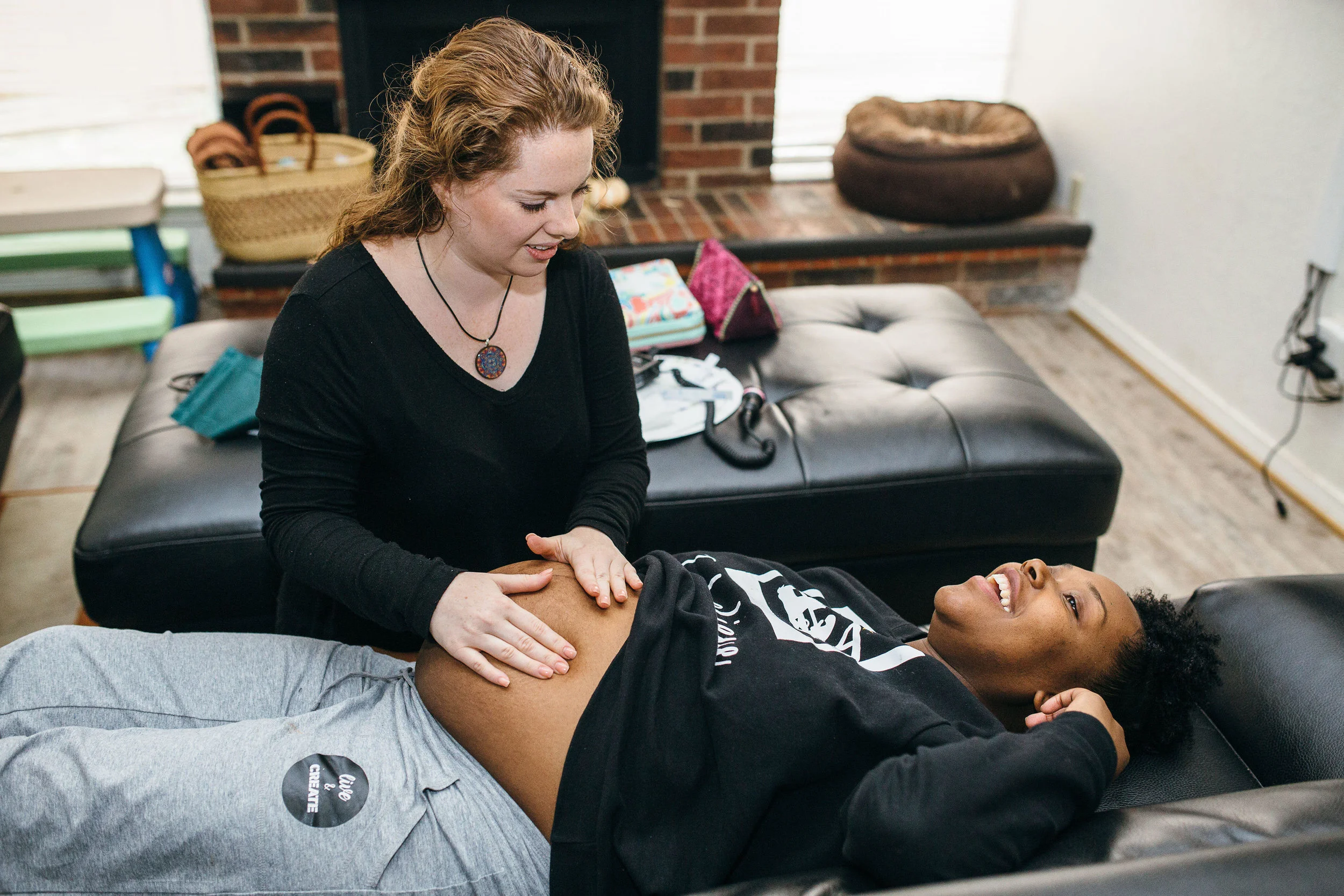 Bethany Stricker, Co-founder of Abide supporting a client during a prenatal appointment. Photo Courtesy of Lane B. Photography.