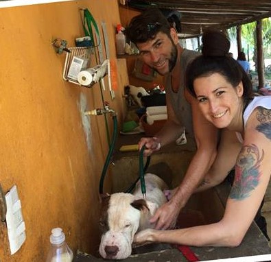 PICTURE OF A COUPLE BATHING A DOG.jpg