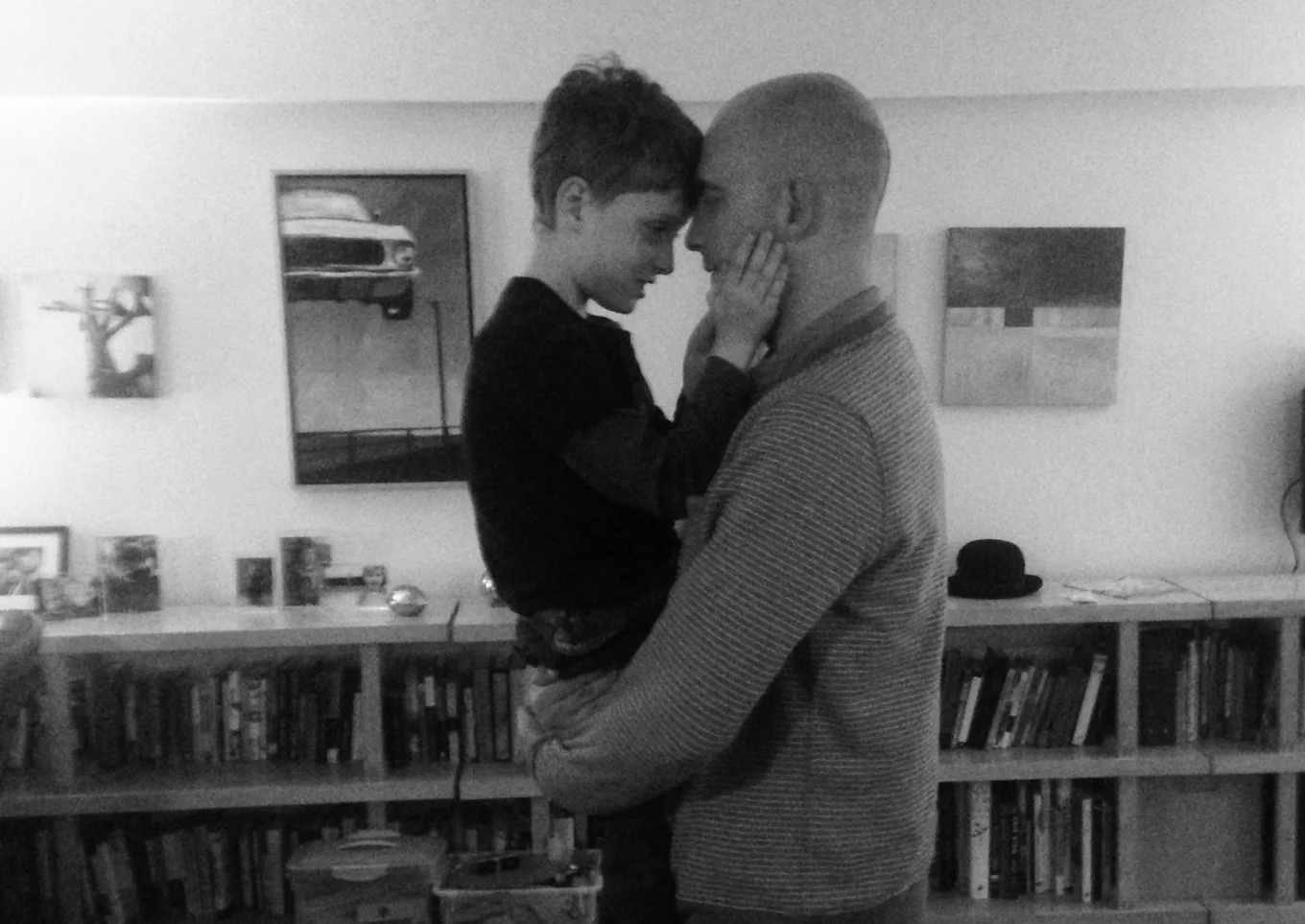 A small boy is hugged by his male therapist