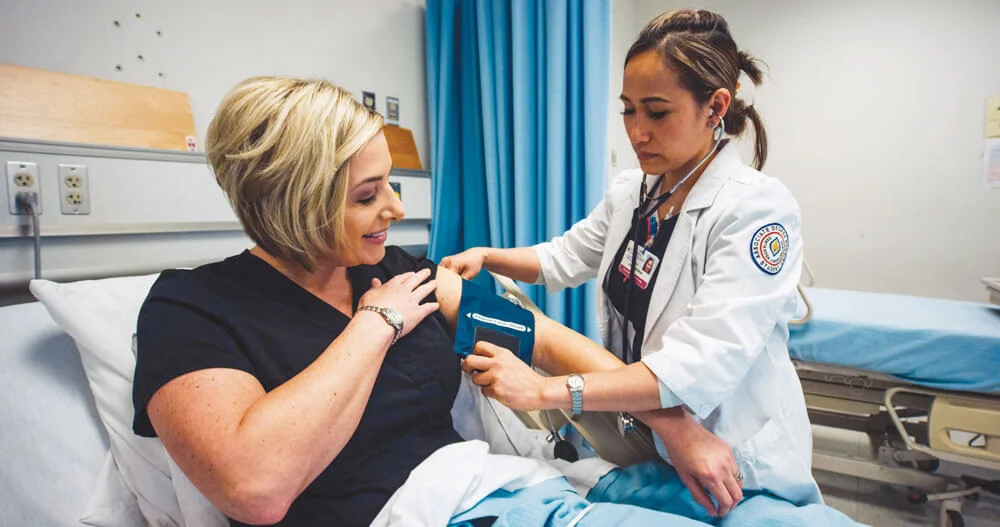 nursing_student_taking_blood_pressure_with_patient.jpg