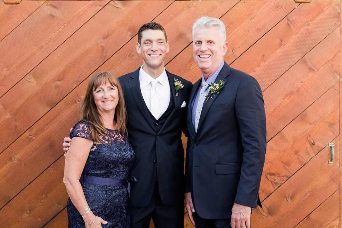 groom with parents picture.jpg