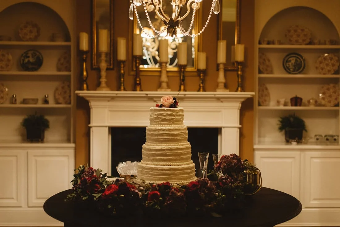 simple wedding cake with floral on top.jpg