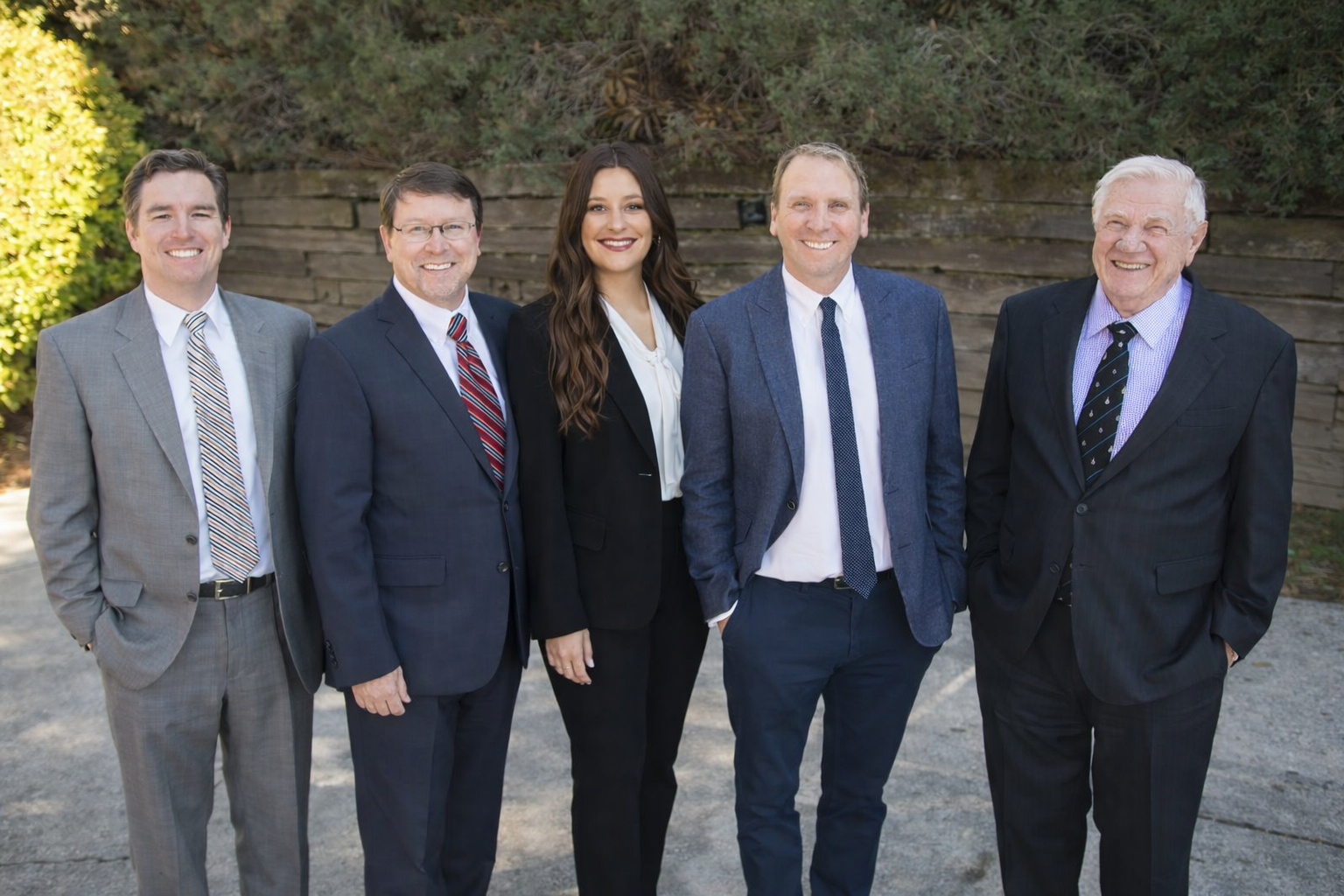 Team of professionals outdoors on a sunny day.png