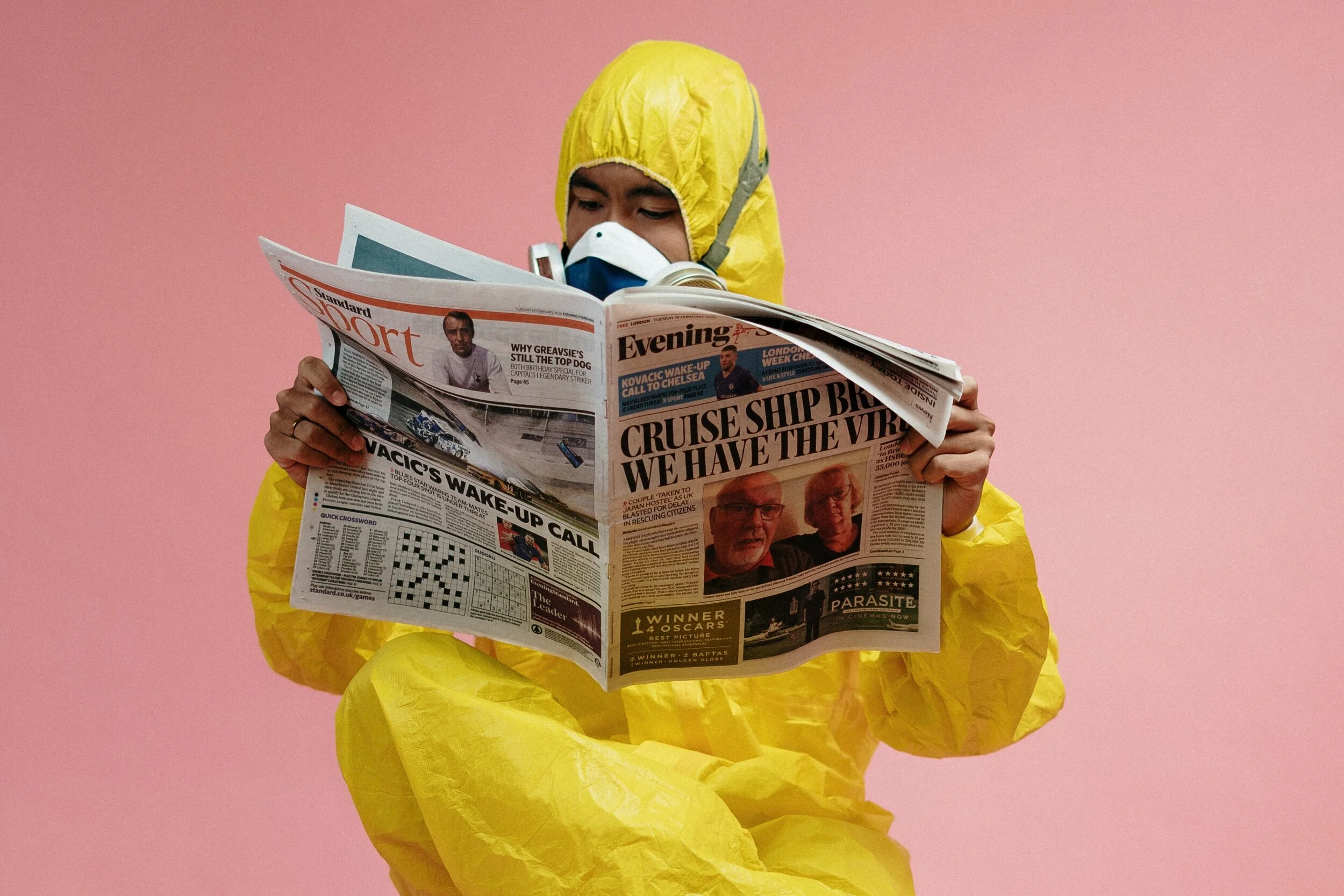 man-in-yellow-protective-suit-holding-a-newspaper-3951350.jpg