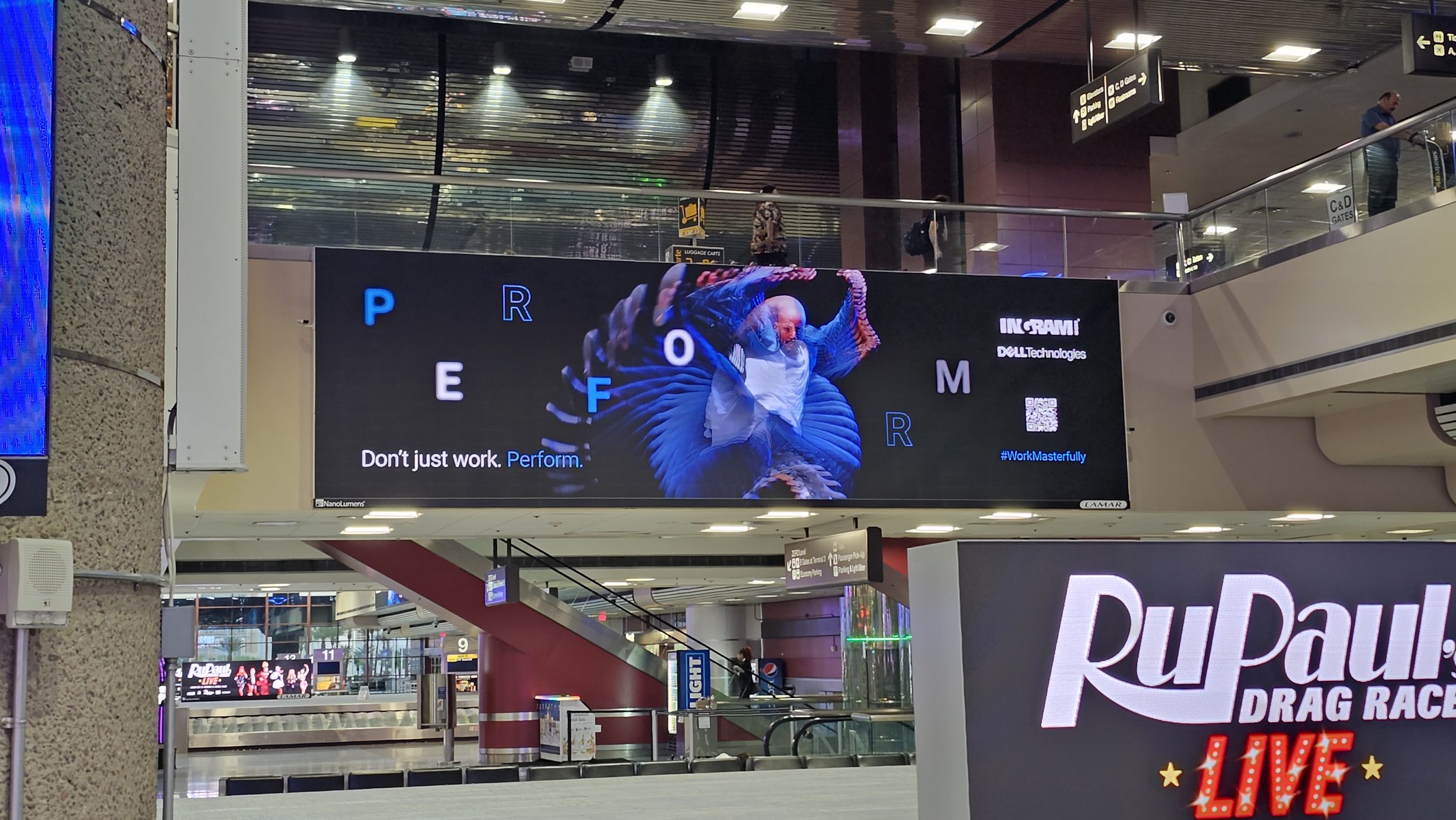 Still shot of the digital video playing on another giant LCD screen in the terminal