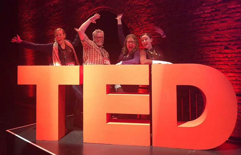 The TEDxMcMinnville team snuck on stage for a pic with the TED logo!