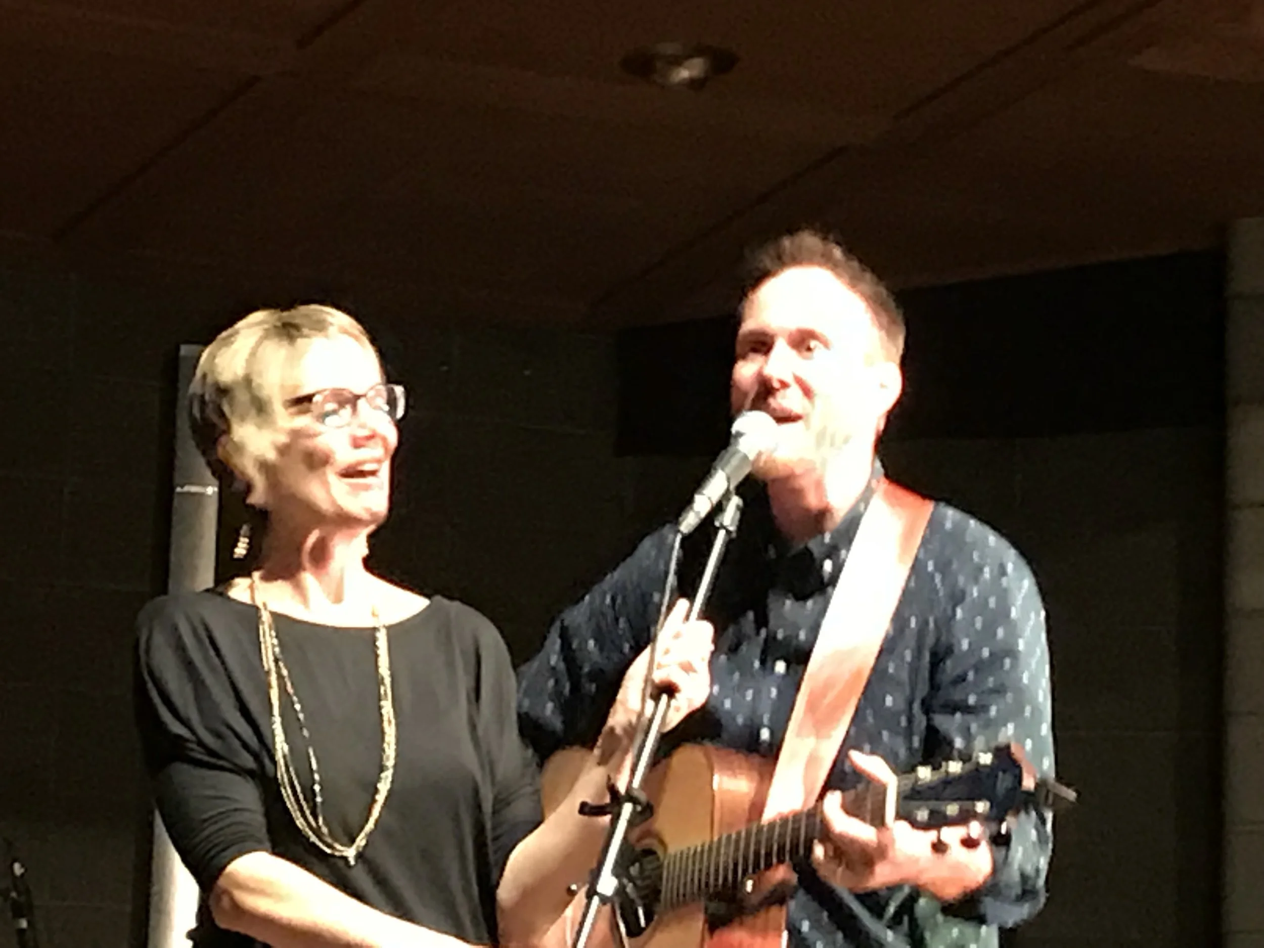 Impromptu mic holder and singer after the stand broke at the end of the concert.