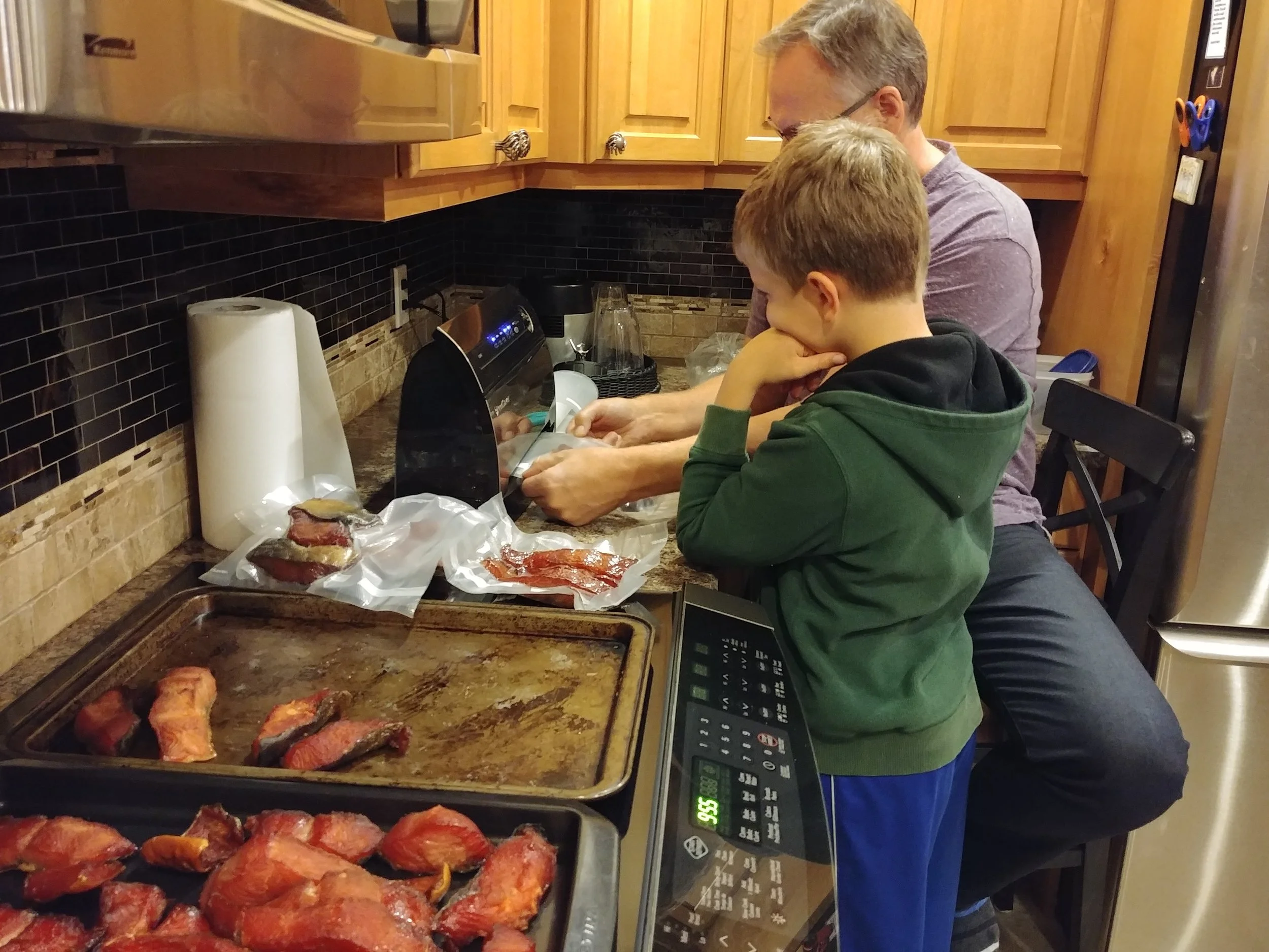 Sid vacuum-packing the salmon Jer caught and Sid smoked…