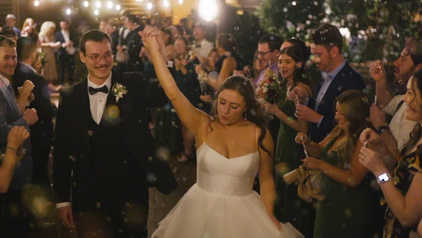 The couple celebrating with guests on a packed dance floor