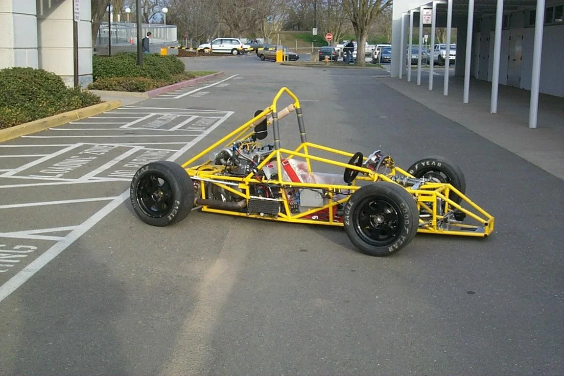 1996 Car Top Speed: 120 mph Acceleration: 0-60 in 3.5 seconds Power: 118 hp @ 13,500 rpm Torque: 48.6 lb/ft @ 11,250 rpm Cornering: 1.5 G Weight: 527 lbs Engine: Honda CBR 600rr Transmission: 6-Speed Sequential Differential: Taylor Race Mk2 Limited Slip Frame: Tubular Steel Space Frame Suspension: Triplex/pull-rod Dampers: Kaz Tech 7800DA Tires: Hoosier 20.5 x 6.0 - 13, R25B Electronics: AEM Series 2 ECU Data Logger: Race Technology DL1