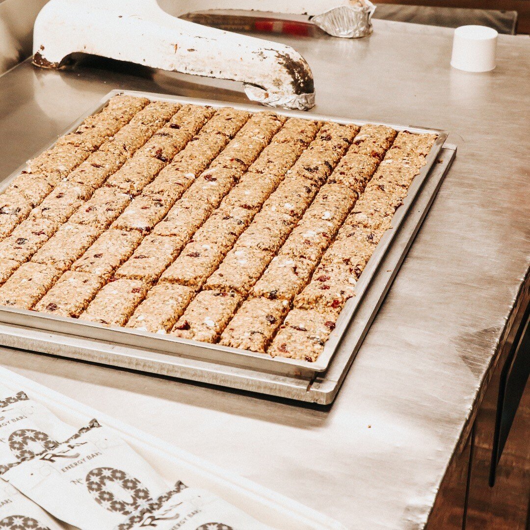 After mixing and weighing out the ingredients for Real Energy Bars, we hand press the batter. It is rolled
and baked, before we are able to cut it with the custom grid. Shop our bars online #Linkinbio or come to @ovensoffrancect @neatdarien @pattyspa