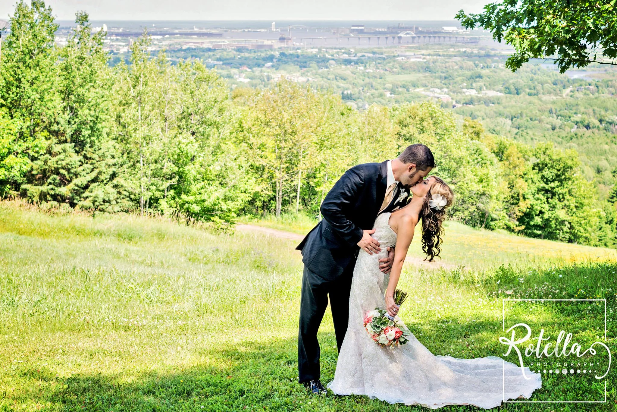 Bride and groom kissing at spirit mountain, duluth