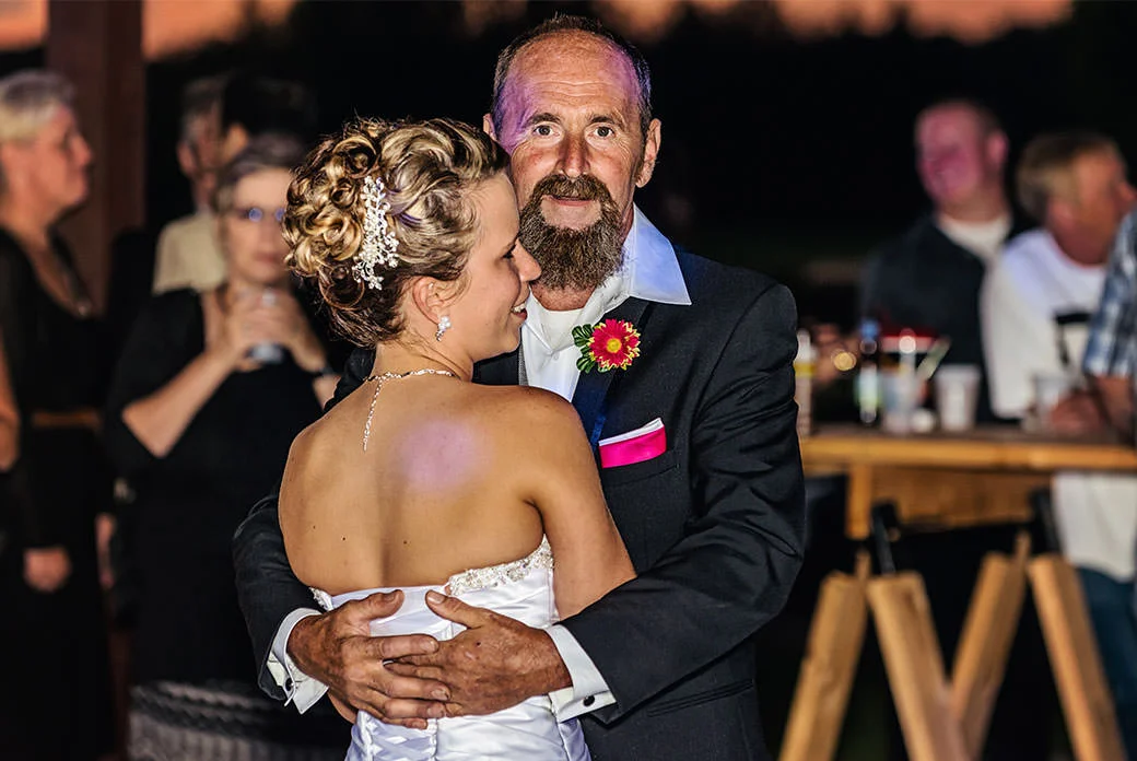 Father of bride smiling while dancing with daughter - Rotella Photography