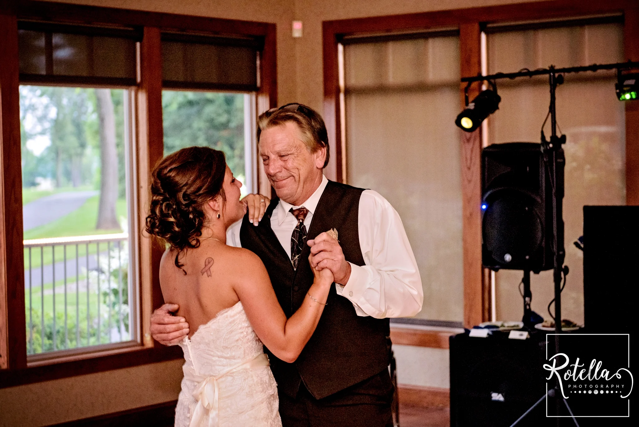 Father of bride smiling while dancing with daughter - Rotella Photography