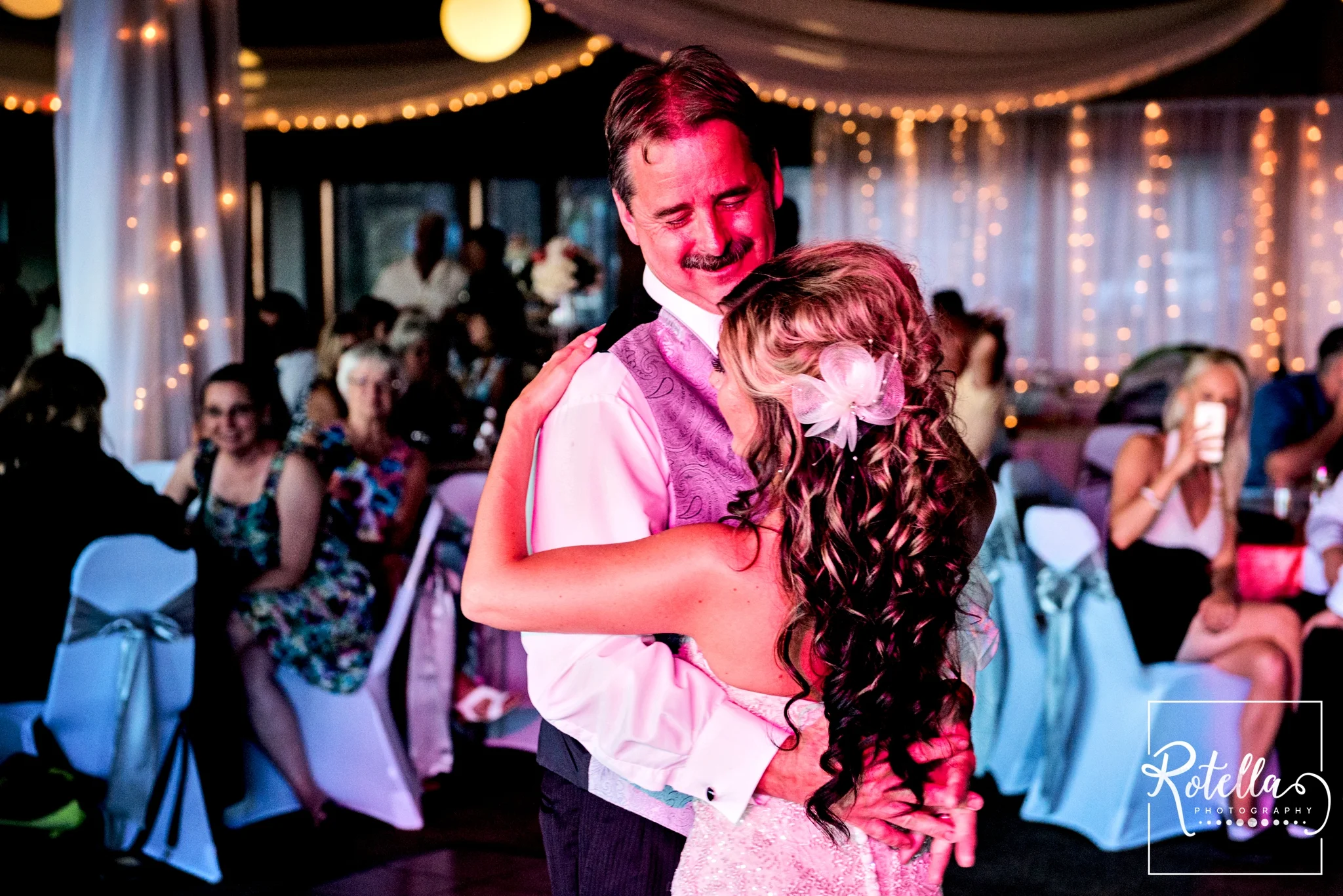Father of bride smiling while dancing with daughter - Rotella Photography