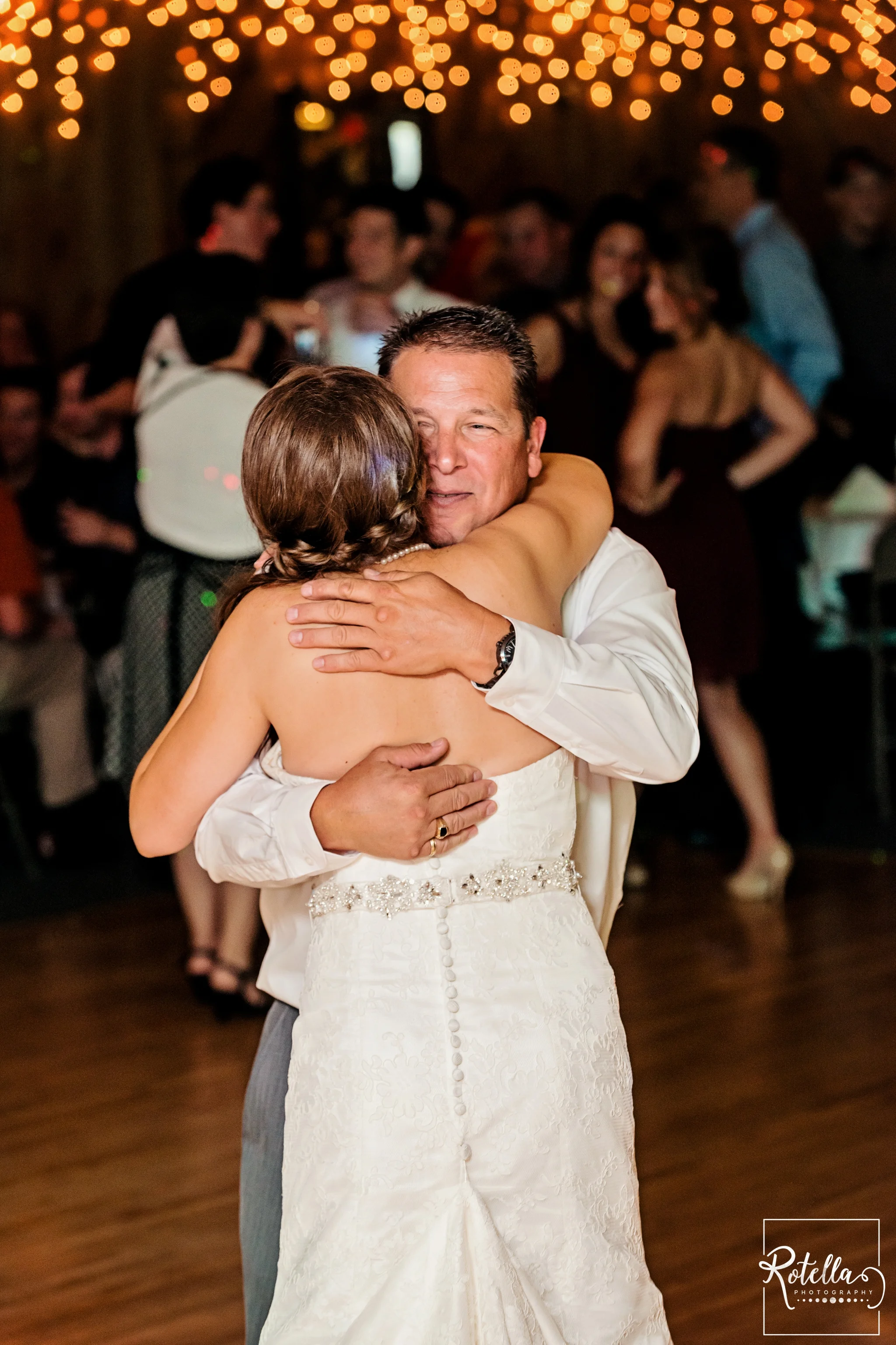 Father of bride smiling while dancing with daughter - Rotella Photography
