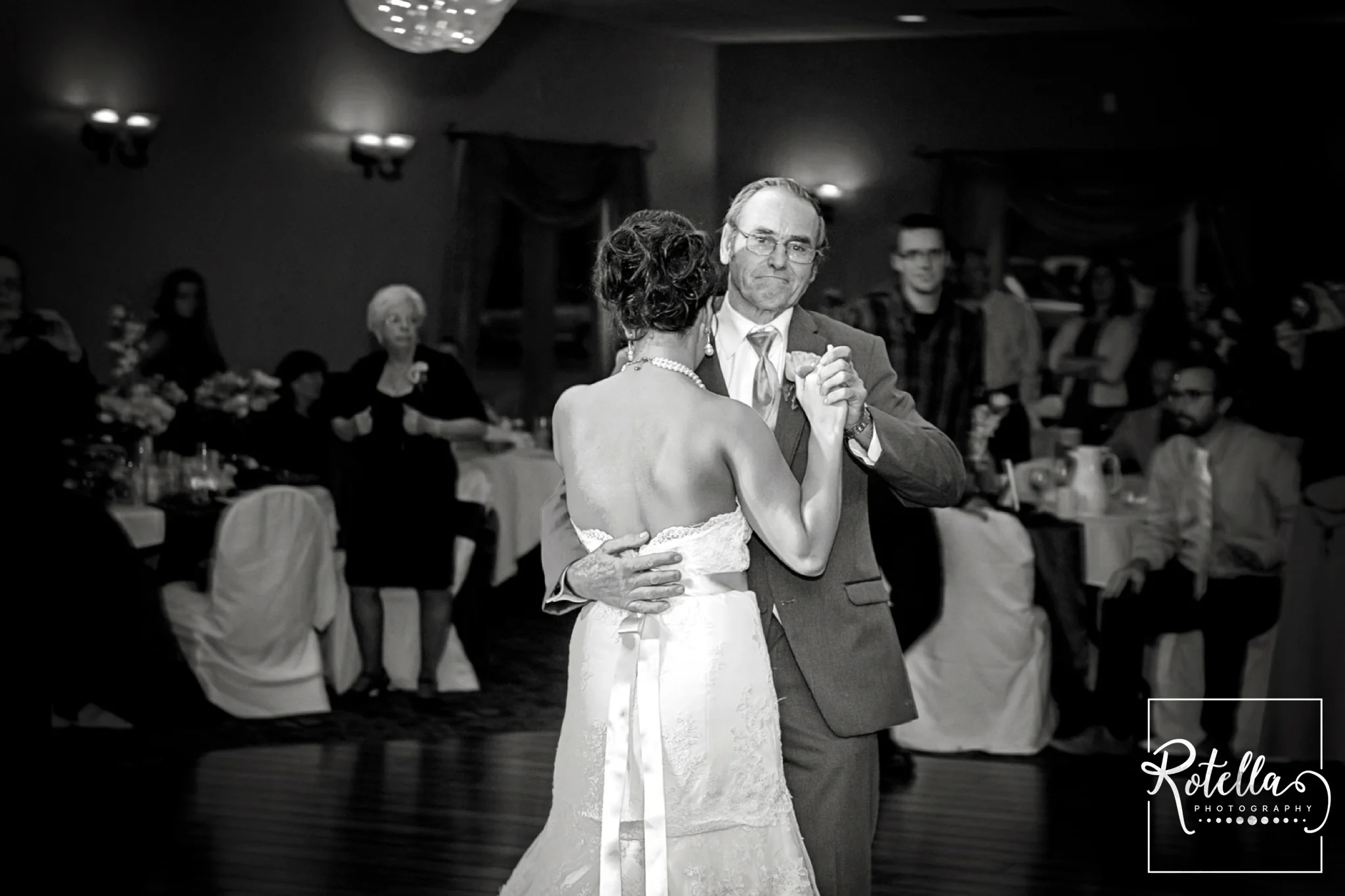 Father of bride smiling while dancing with daughter - Rotella Photography