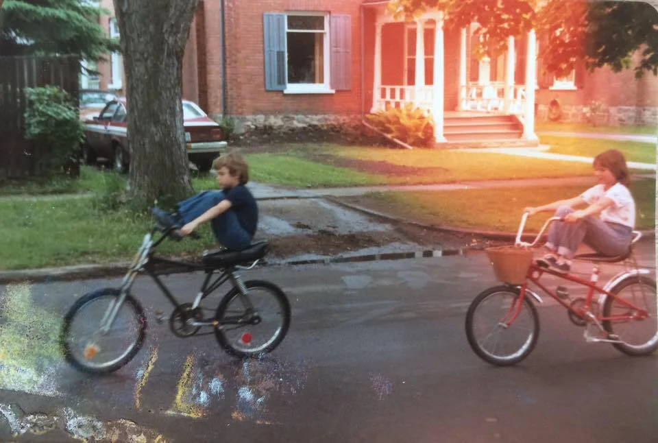 My brother, Dougie and I tooling around on our bikes on Homewood Avenue in Peterborough, Ontario, circa '81 -- the same bikes we would have thrown down on the sidewalk outside Parkway Variety.