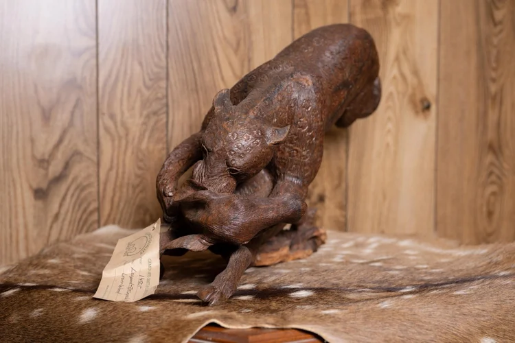 Leopard attacking impala carved in ironwood, South Africa