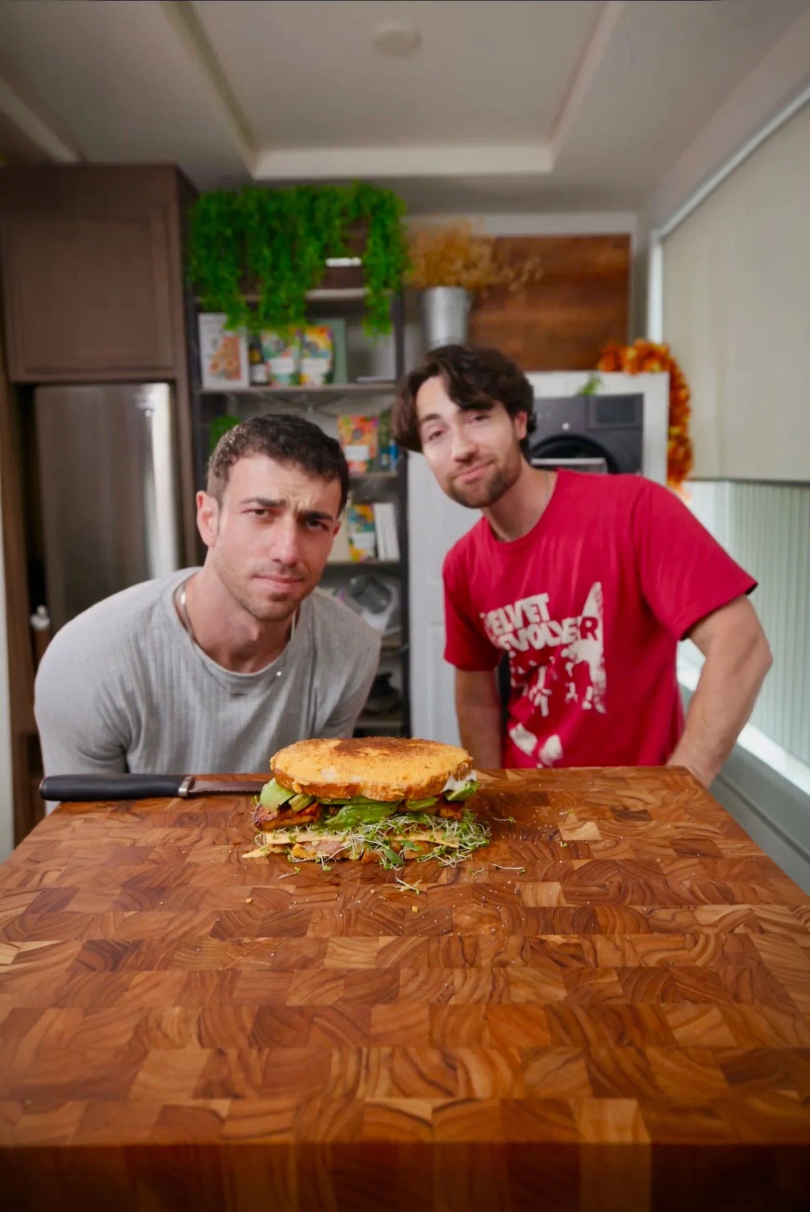 plant based chefs using broccoli sprouts to make a sandwich for dinner in los angeles. Mario and Justincooksgood are influencers and vegan content creators.