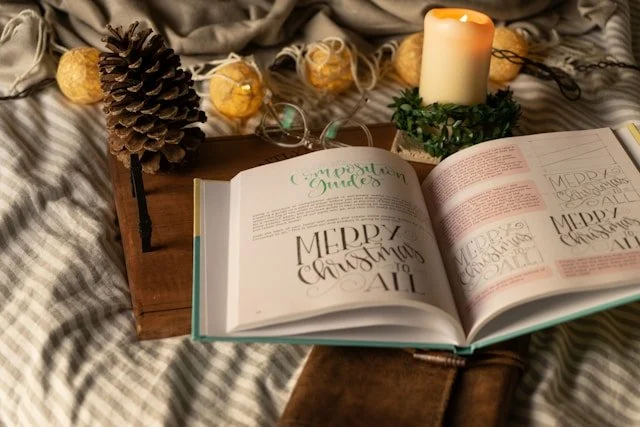 Book open on a tray with Christmas decorations