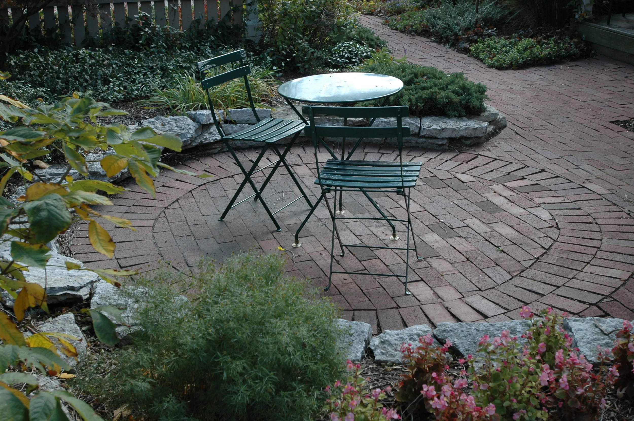  Round brick patio for small dining area. 