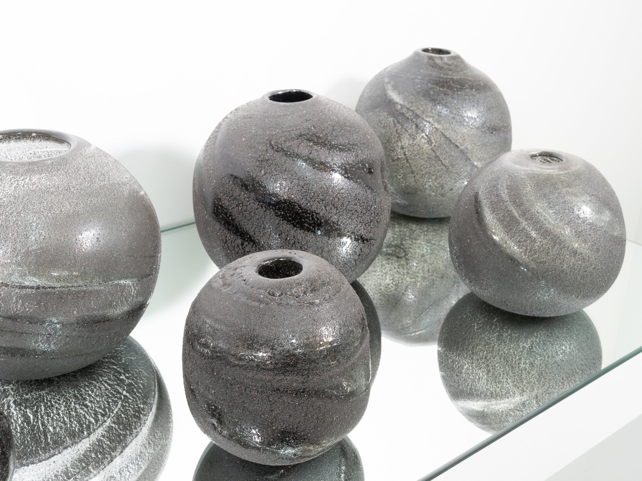 Group of Black Volcanic Sand Moon Jars.