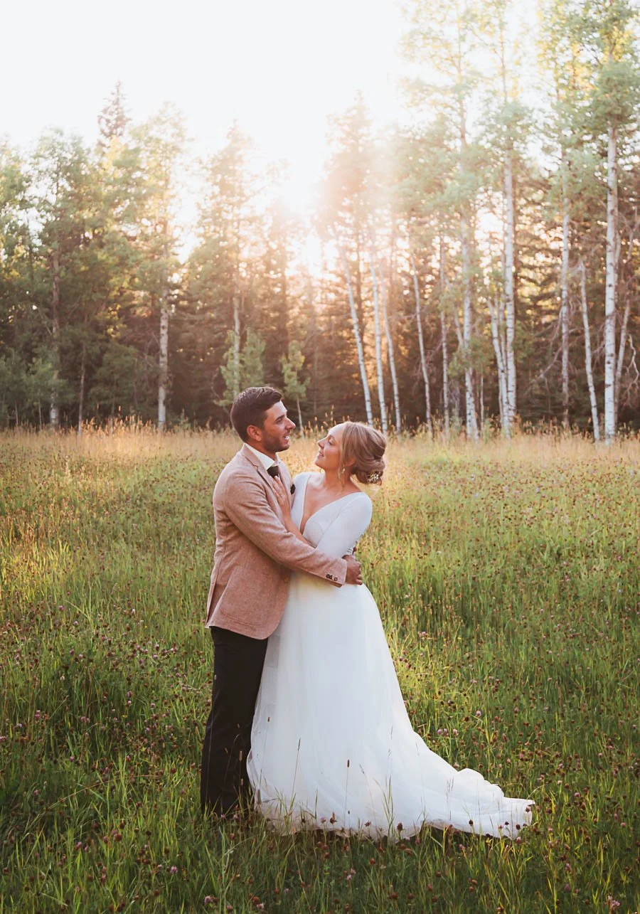 Rustic wedding couple celebrating in Cremona Alberta with prairie landscape, golden light, and natural outdoor country setting