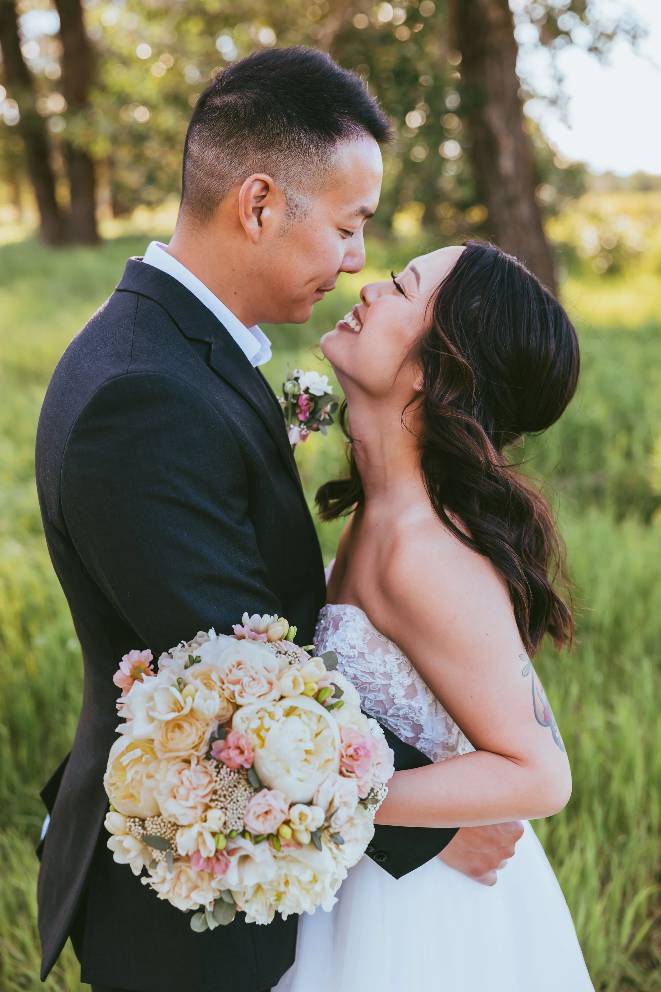 Casual elopement couple in Calgary park with natural greenery, soft light, and relaxed classic wedding attire during outdoor ceremony