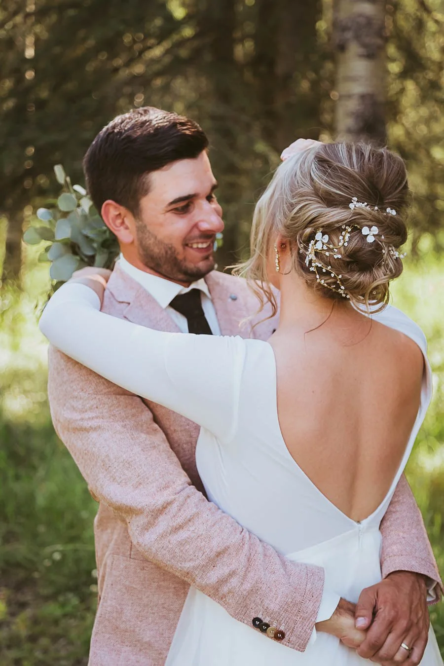 Rustic wedding couple celebrating in Cremona Alberta with prairie landscape, golden light, and natural outdoor country setting