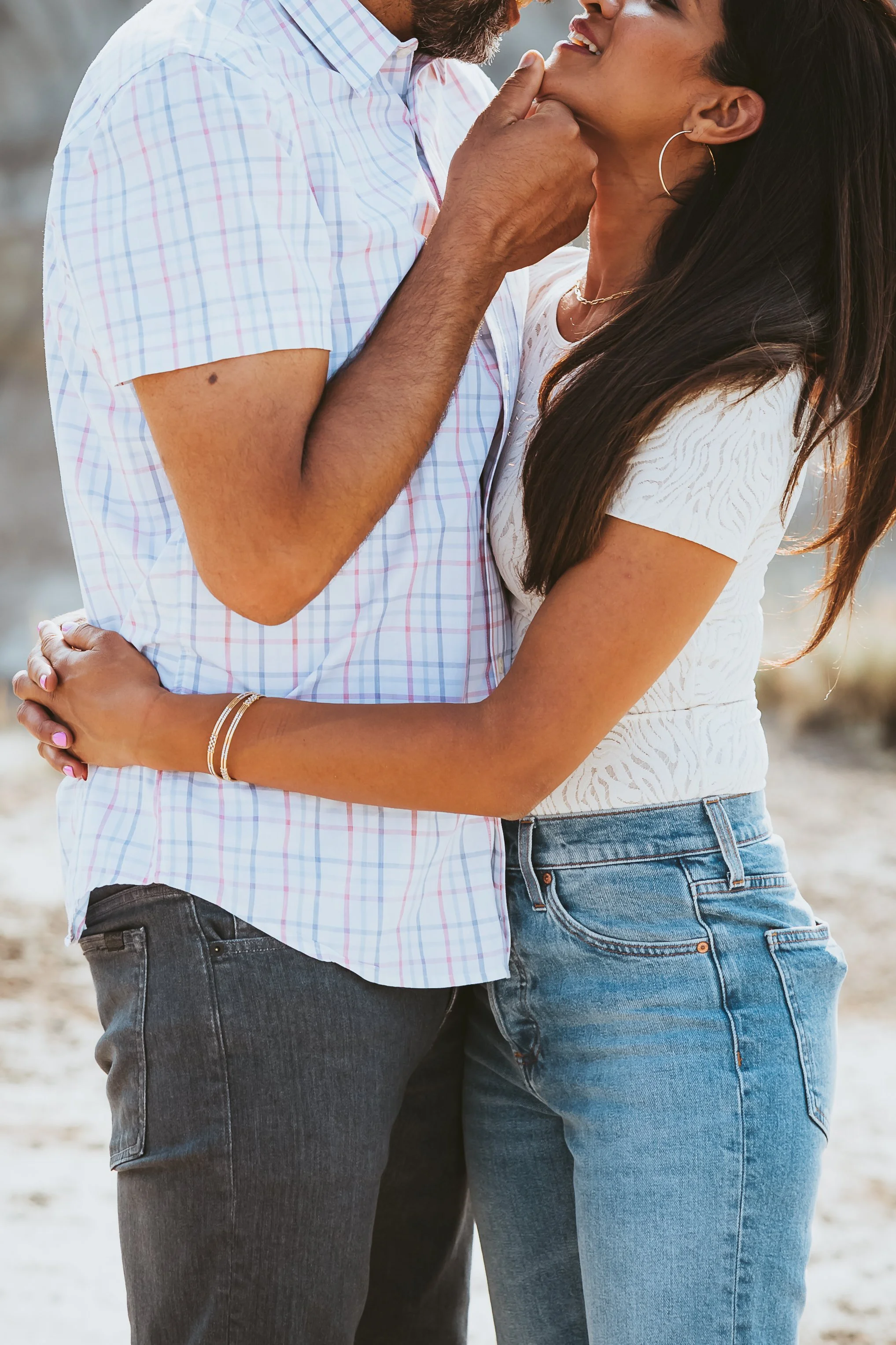 Close-up of a couple embracing during a family photoshoot in the Alberta Badlands at sunset