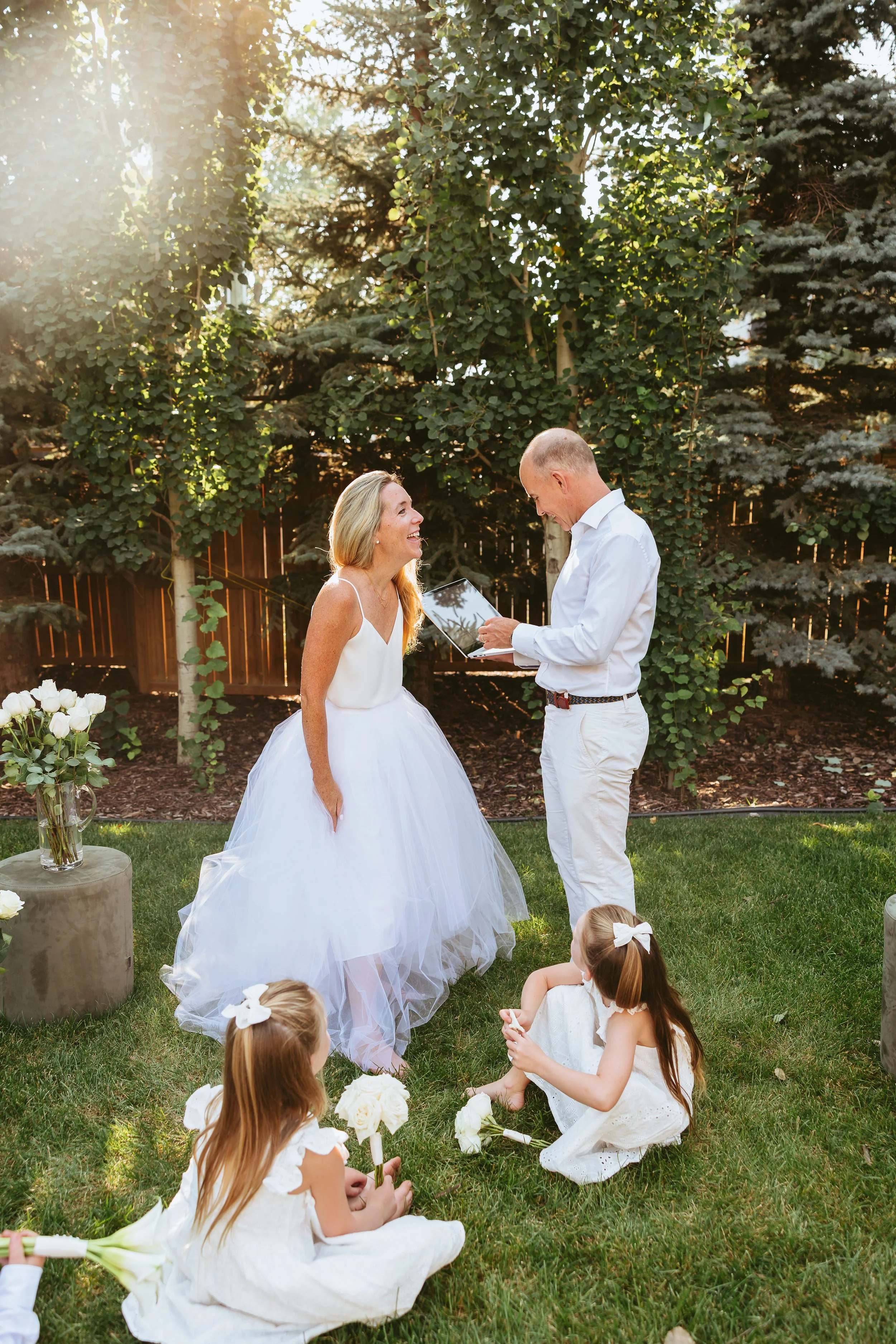 Couple sharing vows with their children during an intimate backyard wedding in Calgary, an alternative to a traditional wedding ceremony.