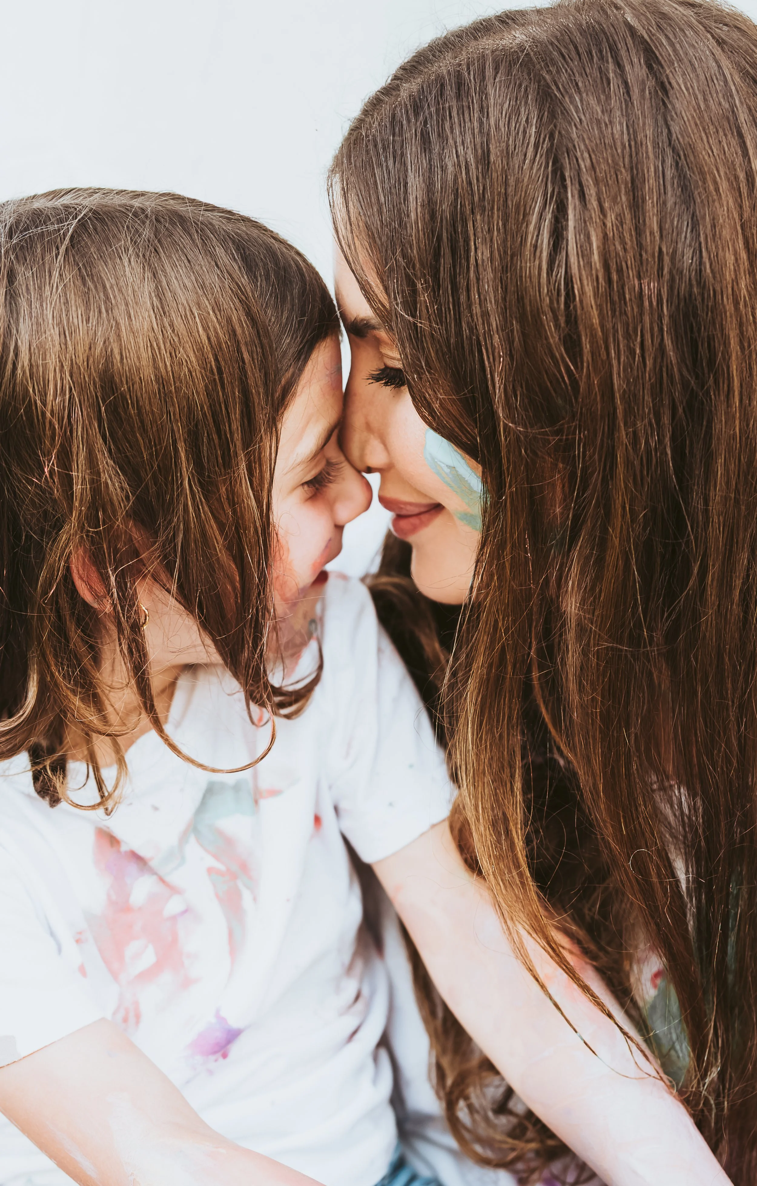 Close up of mother daughter in creative and laid back art paint mini session photoshoot by Maxine LaGarde Photography.